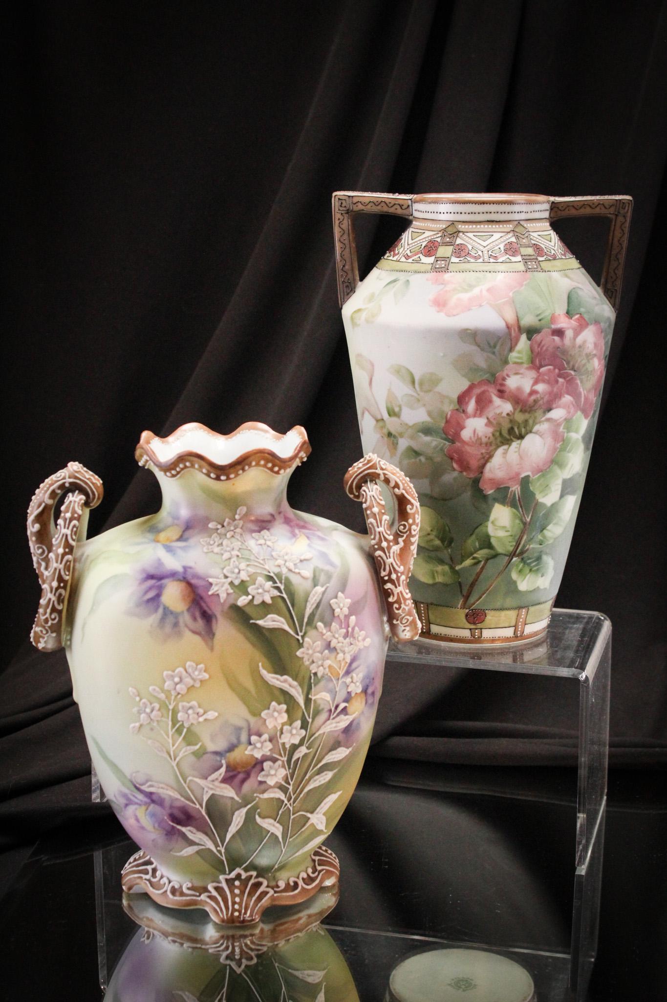 2 pc lot Nippon Moriage Floral Hand Painted Vases: Select offering of two wonderful hand painted vases: One blue mark, one green mark. Both are with handles. Tallest measures 8 1/4" tall.