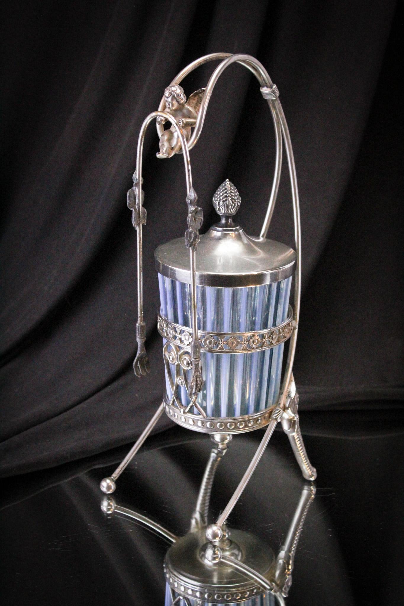 Tufts Silverplate Victorian Beatty Blue Opalescent Cherub Pickle Castor: Killer example of a signed Tufts Victorian silverplate Beatty Rib pattern blue opalescent Cherub topped pickle castor along with elephant head legs. Complete and original. This lovely castor jar had b