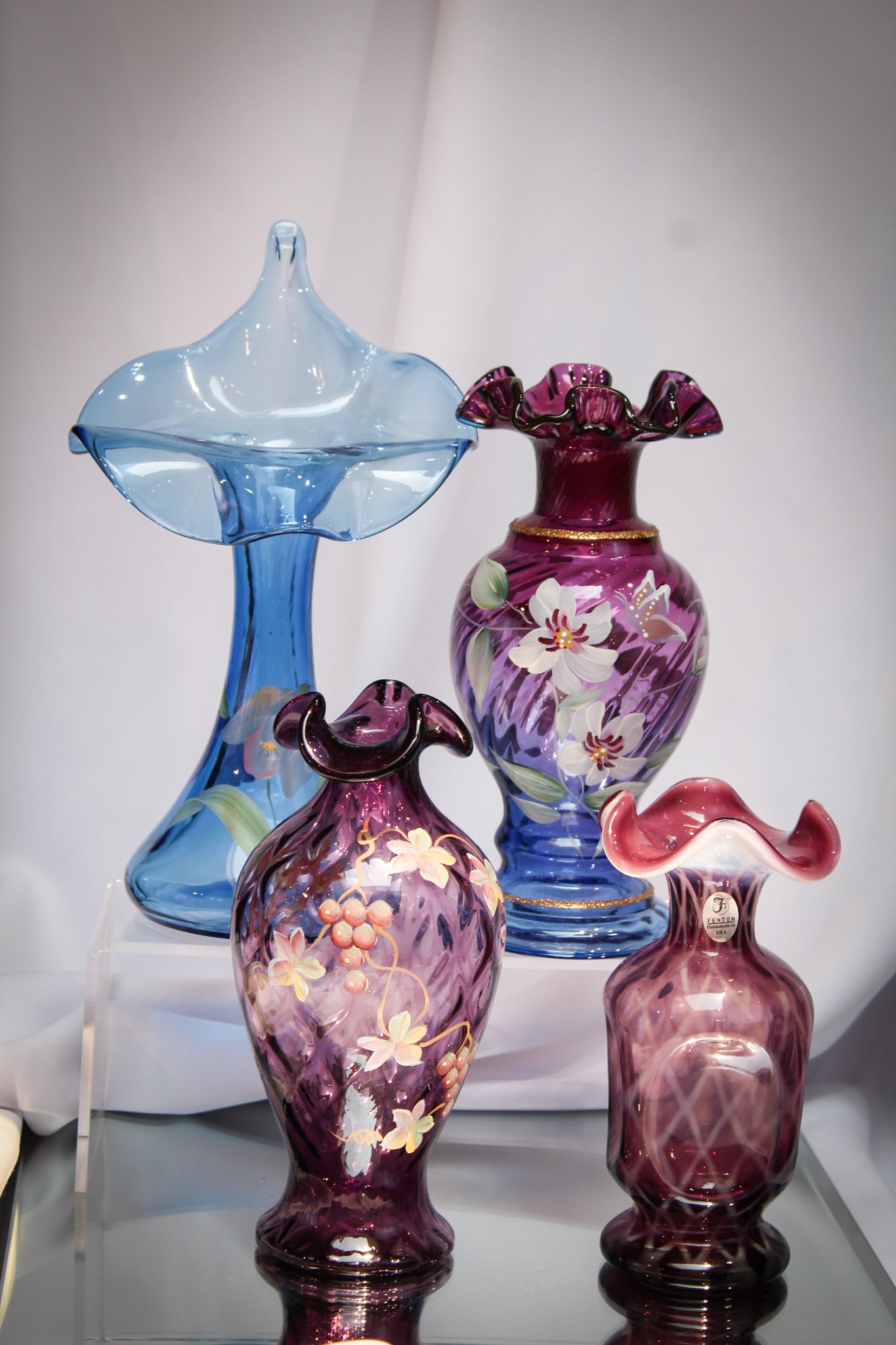 4 pc Lot Fenton Glass Hand Painted & More: Great offering of four pieces of Fenton art glass comprised of mulberry, purple opalescent, blue. Featuring a jack in the pulpit vase. Three of which are hand painted.