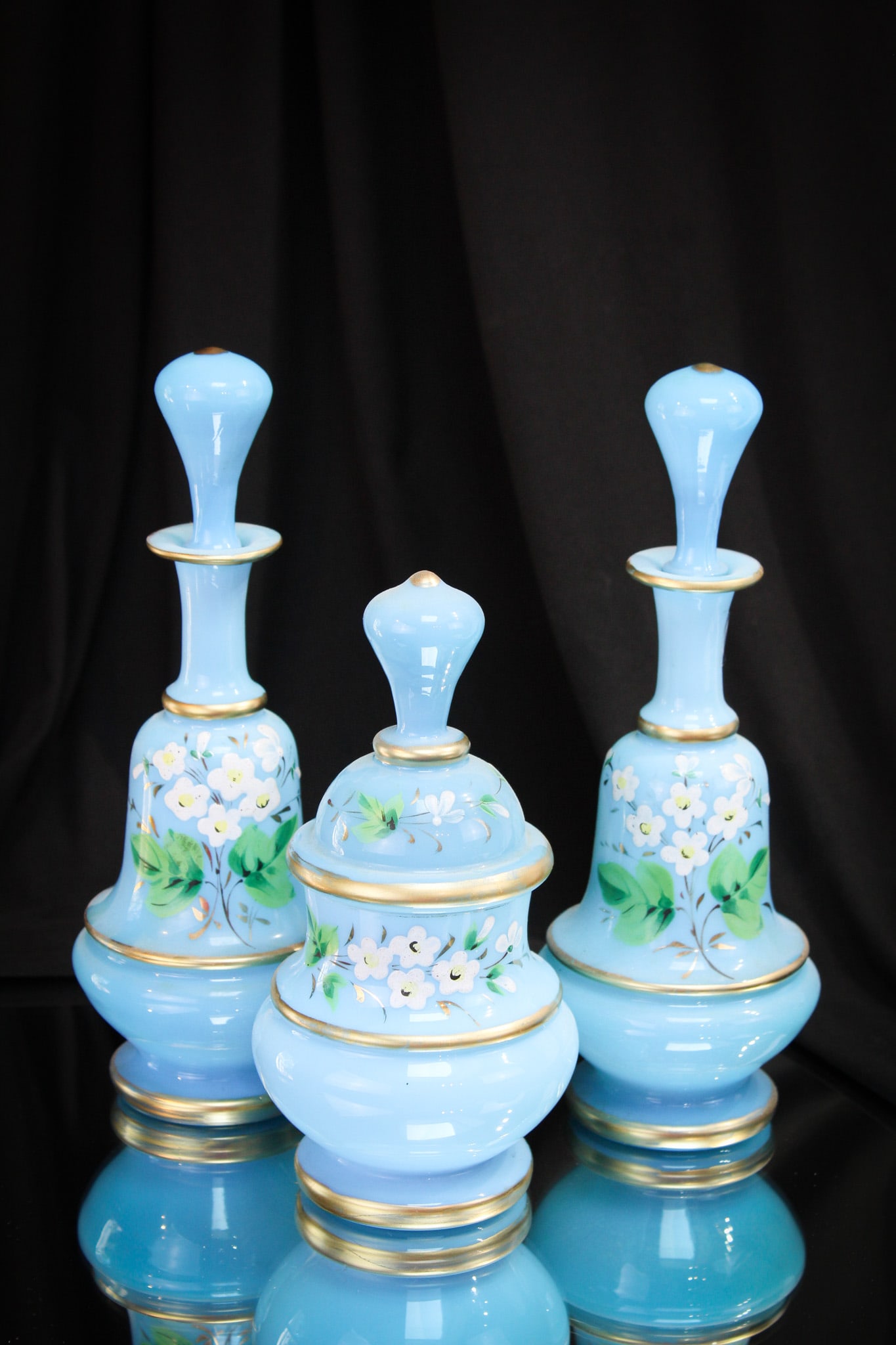 Victorian Blue Bristol Glass Enameled Vanity Dresser Cologne Bottle Set: What a nice set this is folks. Each bottle is in a baby blue bristol glass with lots of gold and enameled floral decoration. Each complete with the original stopper. Nice offering and hard to find com