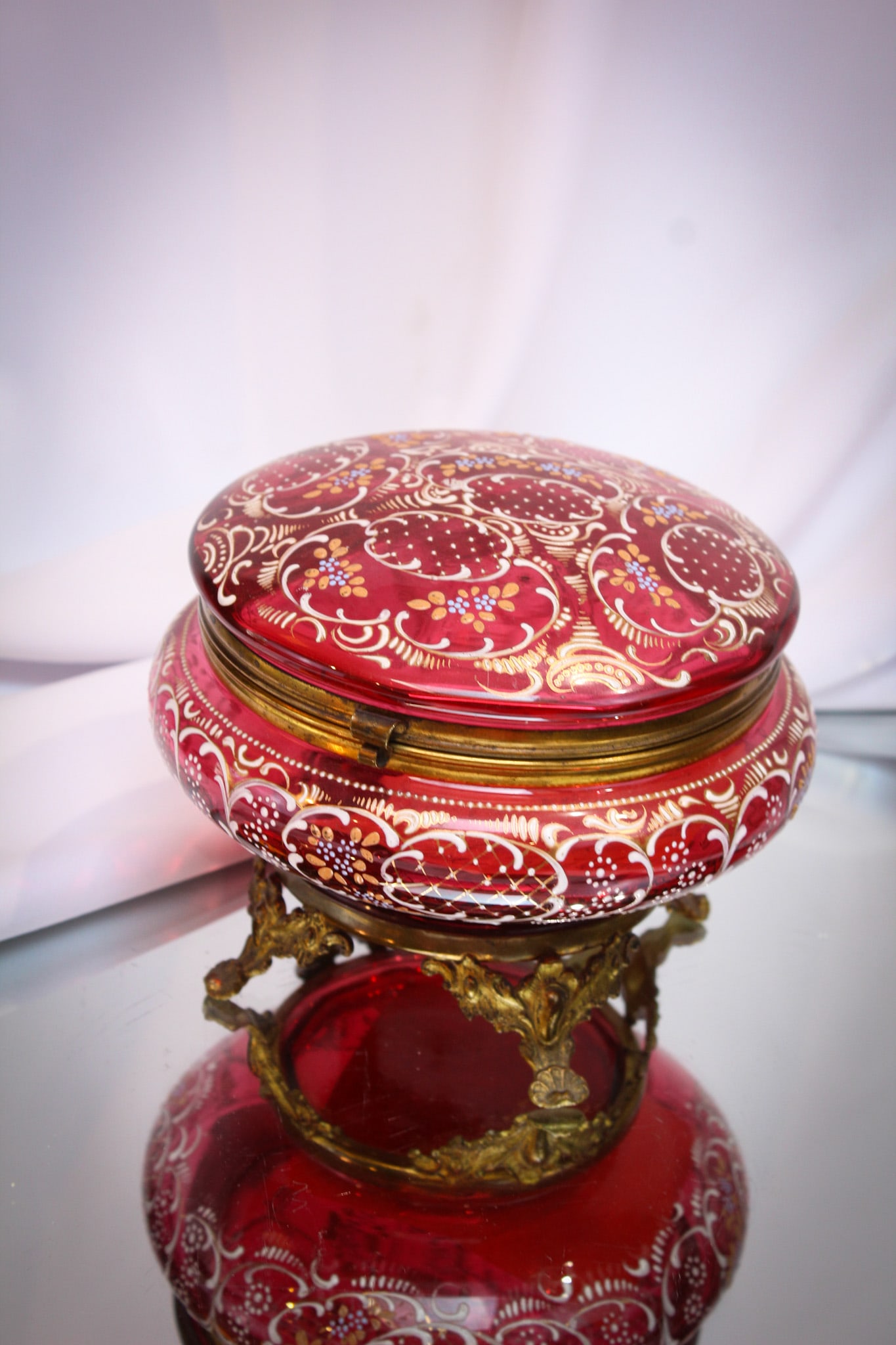 Large Cranberry Gilt Enameled Victorian Dresser Jewelry Casket: Fine example of Victorian cranberry glass gilt and enameled to the hilt in the form of a dresser box or jewelry casket. Nice and big for all of you size queens out there! It measures a whopping 4 1/2"
