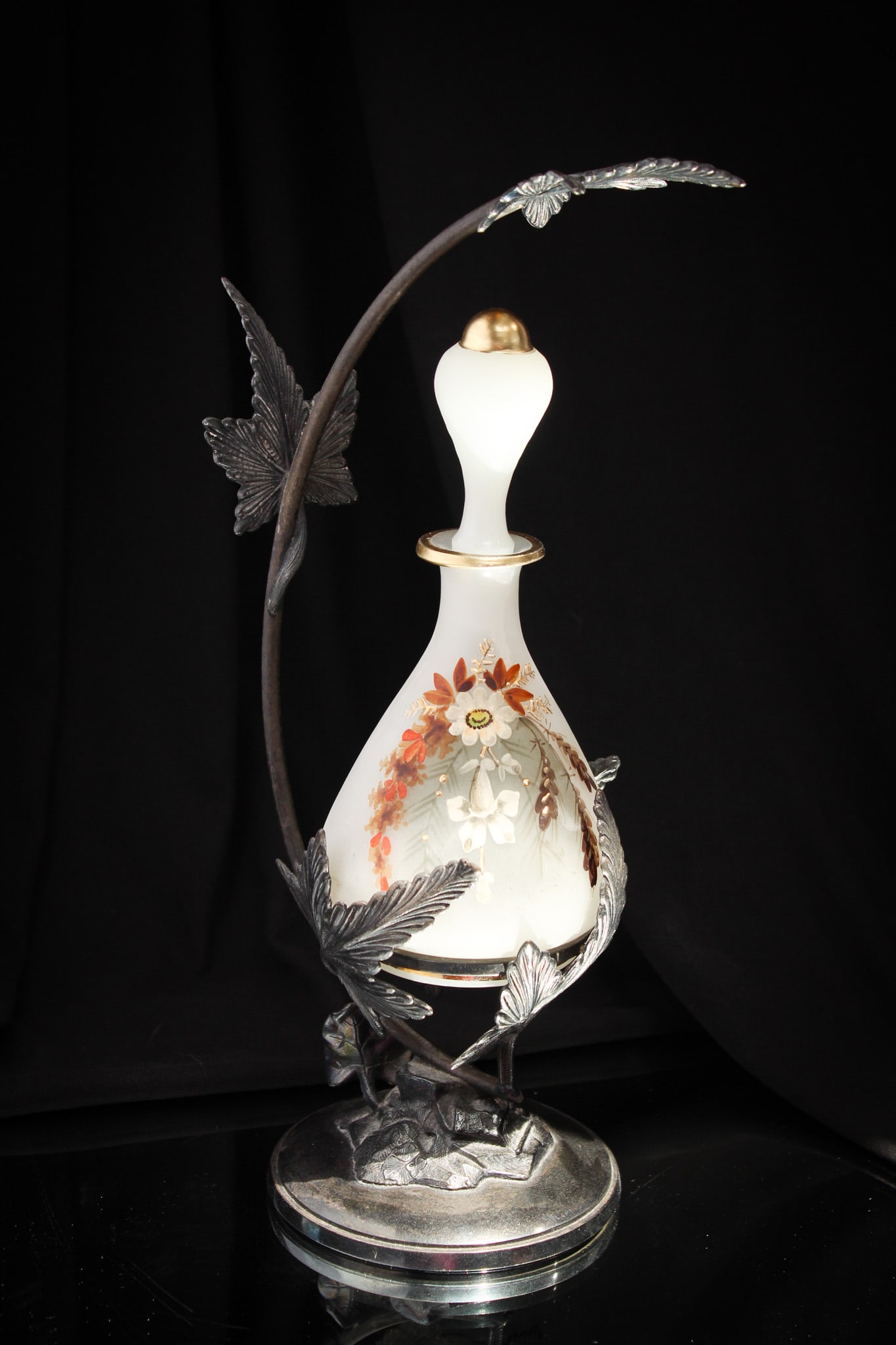 Meriden Silverplate White Opaline Victorian Glass Perfume Castor: Wonderful opaline perfume bottle set in original signed Meriden silverplate leaf adorned castor frame. Bottle is floral decorated and highlighted with gold. Very rare to find complete.