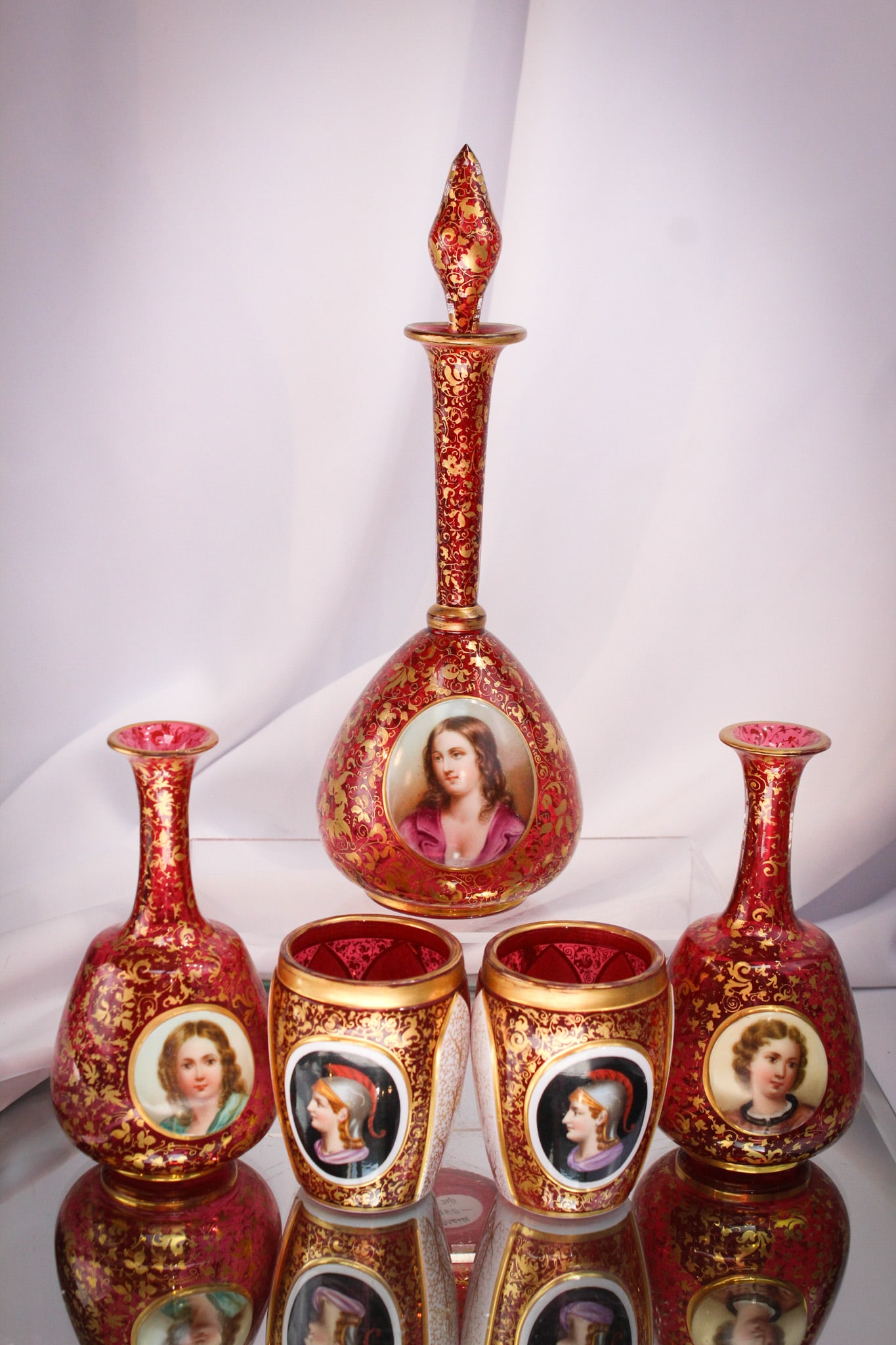 5 pc Lot Victorian Cranberry Moser Glass Portrait Perfume Bottles & More: Beautiful offering of five pieces of Victorian Moser cranberry glass adorned with portraits. Lot is comprised of a cologne bottle, two perfume bottles lacking stoppers, and two handled cups. Very nice