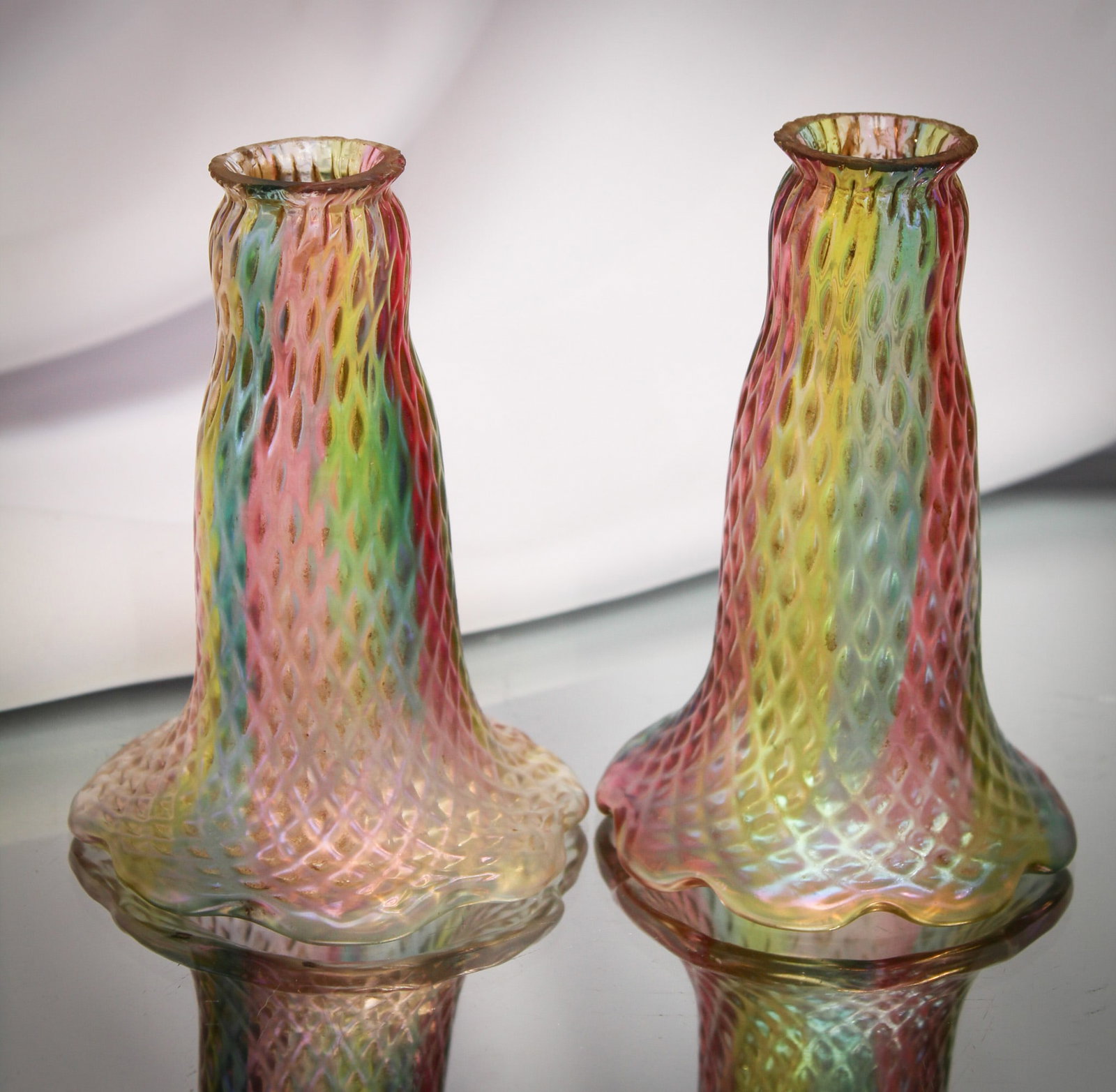 Pr. Rare Rainbow Bohemian Loetz Kralik Art Glass Lily Shades: Select offering here of two lily shades in satin irridescent rainbow glass with concave diamond pattern to the exterior. Attributed to Loetz or another Bohemian glass company of the period. So rare! E