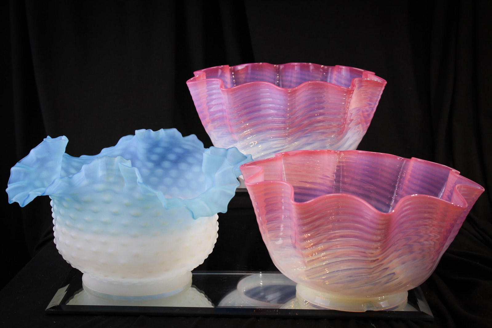 3 pc Lot Victorian Art Glass Shades: Great offering of a pair of pink opal swirl gas shades measuring 4 1/2" by 8 1/4" with a 3 7/8" fitter rim. This pair along with a blue opal satin hobnail example measuring 5" tall, 9" wide and with a