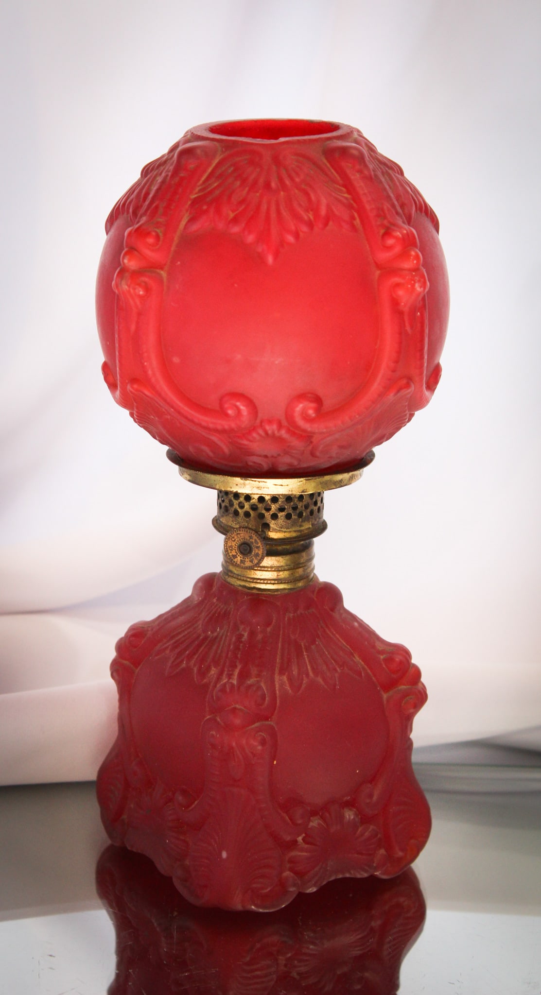 Red Satin Miniature Oil Lamp: Nice little red satin miniature oil lamp with embossed motif.