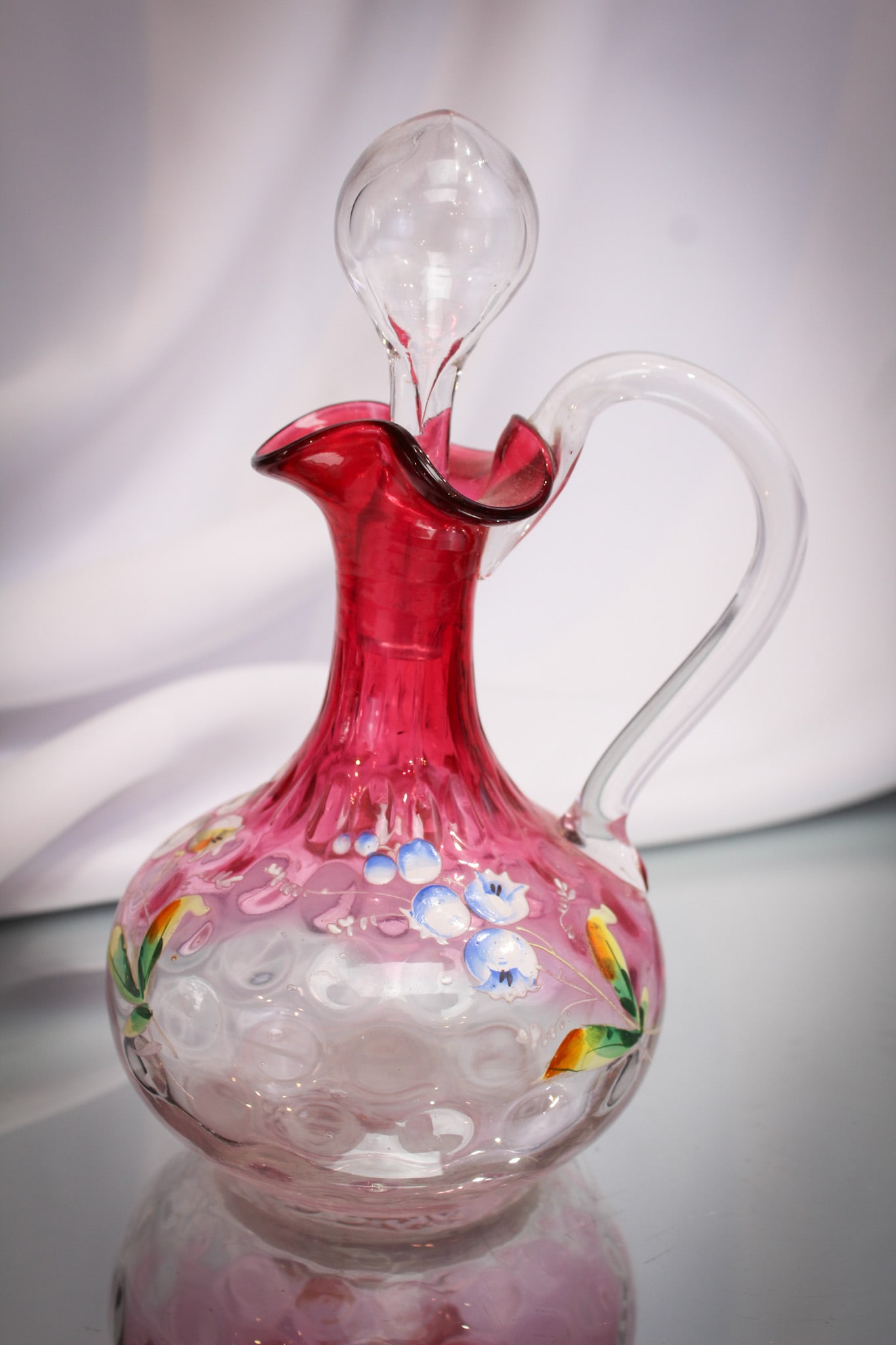 Rubina Cranberry Enameled Victorian Glass Cruet: Fine example of a cranberry enameled rubina Victorian glass cruet with a profusion of flowers adorning it.