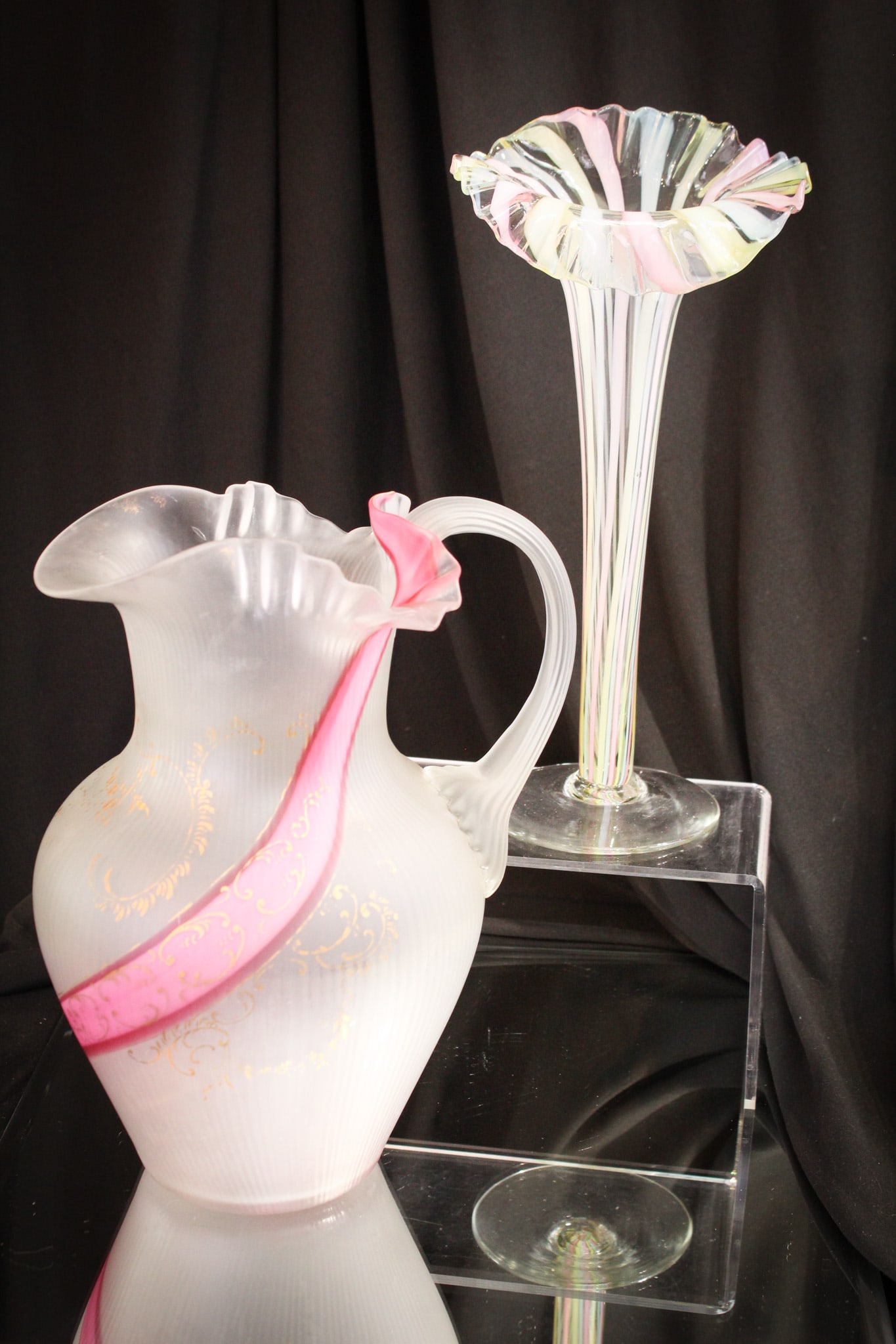 2 pc Lot Victorian Ribbon Art Glass: Select offering of two pieces of Victorian ribbon glass. Lot includes a rainbow ribbon stripe jack in the pulpit form trumpet vase along with a ribbon swirl, attributed to Harrach, Water Pitcher with 