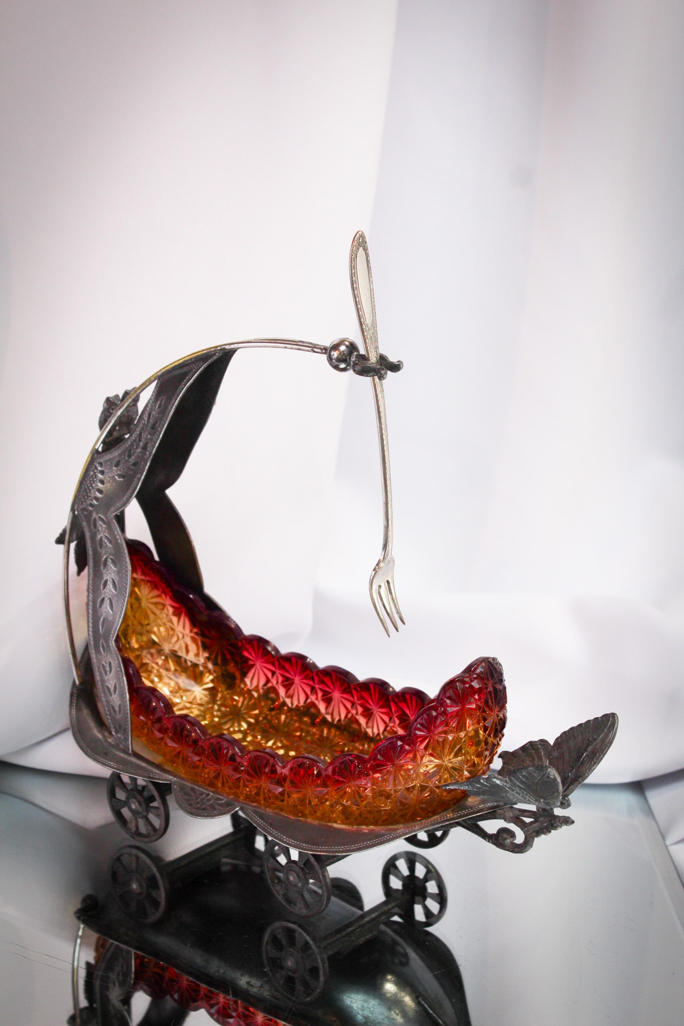 Scarce Homan Silverplate Amberina Daisy & Button Pickle Castor: Rarely found and especially with an amberina canoe, this is a beauty of a pickle castor. Signed "Homan" silverplate figural wheeled cart complete with owl trim and all. This is a toughie!