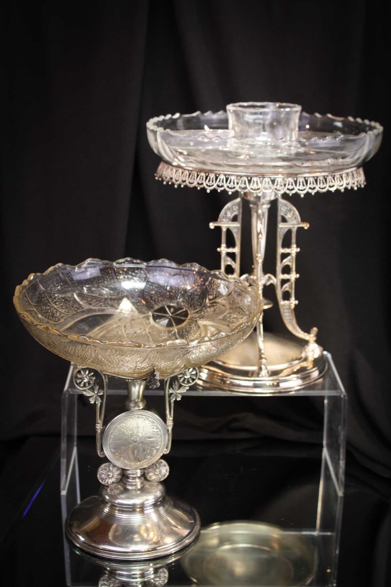 2 pc lot Victorian Meriden Reed & Barton Silverplate: Two fine examples of Victorian silverplate by Meriden and also Reed & Barton. Meriden insert comes complete with medallion adorned center bowl. Reed & Barton example comes with a later associated eleg
