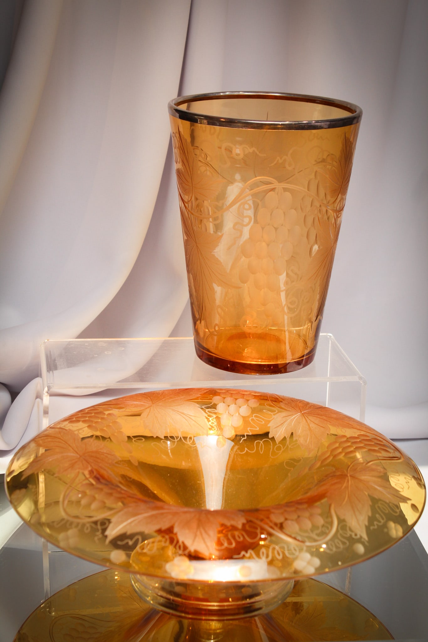 2 pc Lot Pairpoint Grape Cutting Glass Vase & Bowl: Perfect selection of two great pieces of Pairpoint amber glass with grapes cutting. One is a flip vase with silver rim and the other a pedestal bowl. Fine examples of each.