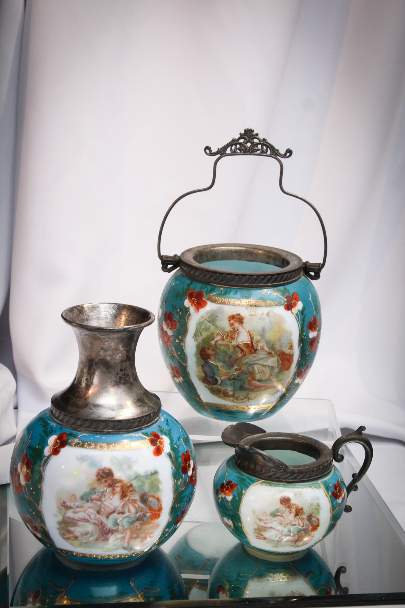 3 pc Lot Victorian Glass Enameled Opal Glass Biscuit Jar & More: Fine offering of three matching pieces of Victorian decorated opal glass comprised by a biscuit jar, a water caraffe, and finally a creamer! All with coordinating decoration.