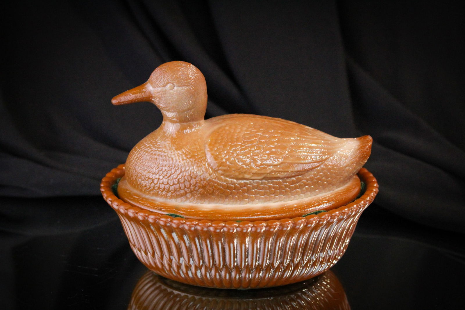 McKee Chocolate Glass Duck on Nest: Another fine rarity among the Greentown and McKee glass we are offering today. This, the duck on nest covered chocolate animal dish, is just that. A rare piece to find and complete on the original bas