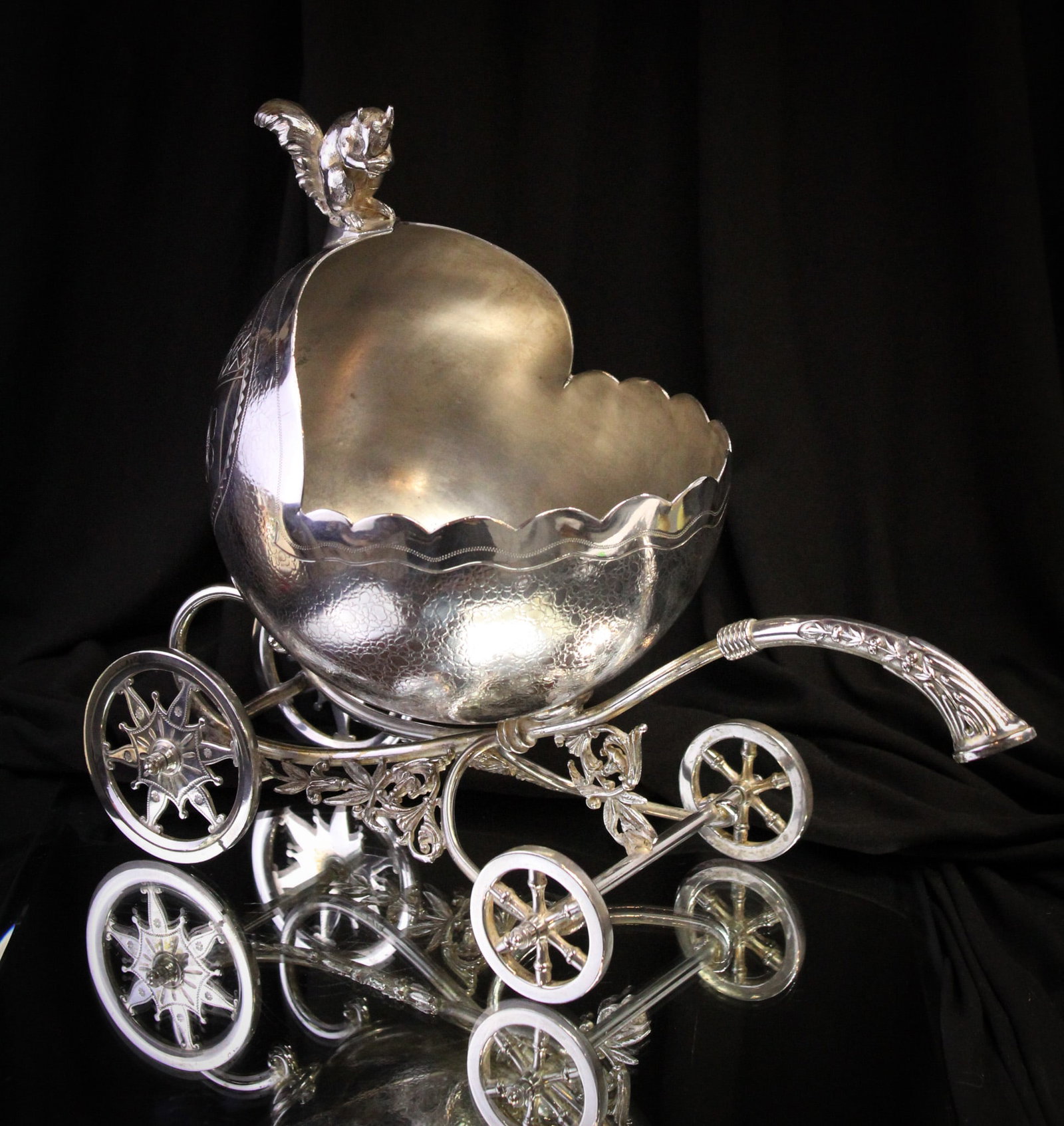 Rare Meriden Silverplate Wheeled Victorian Nut Bowl: Incredible silverplate Victorian nut bowl signed "Meriden." This piece features handle and fully moveable wheels for rolliing across the table. Figural squirrel sits atop guarding his nuts. Beautiful 