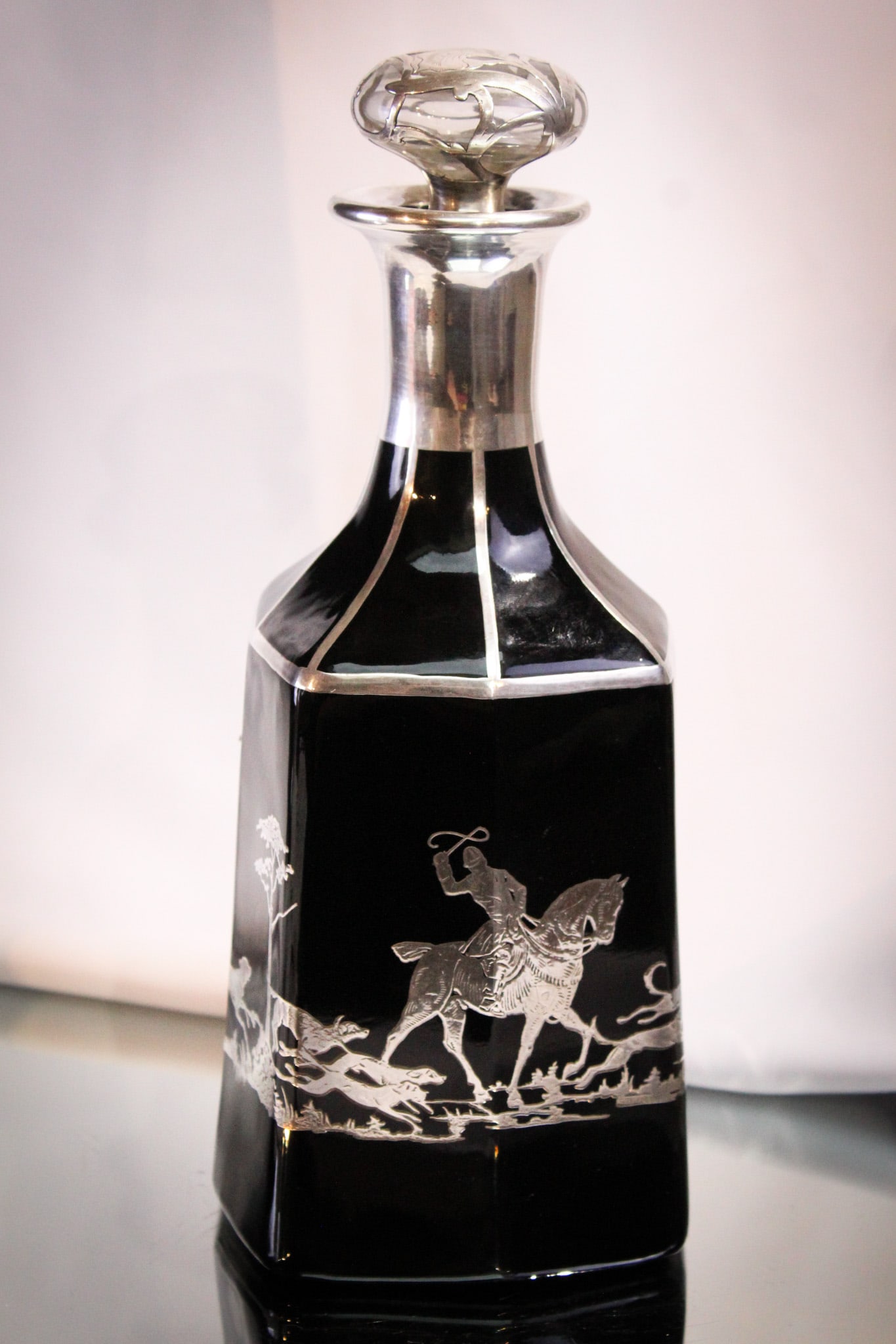 Art Deco Czech Glass Sterling Overlay Hunt Scene Decanter: Great piece of Art Deco period black glass with sterling overlay. Overlay depicts a hunt scene around the body of the black glass decanter. Signed as shown and believed to say "Czechoslovakia." Great 