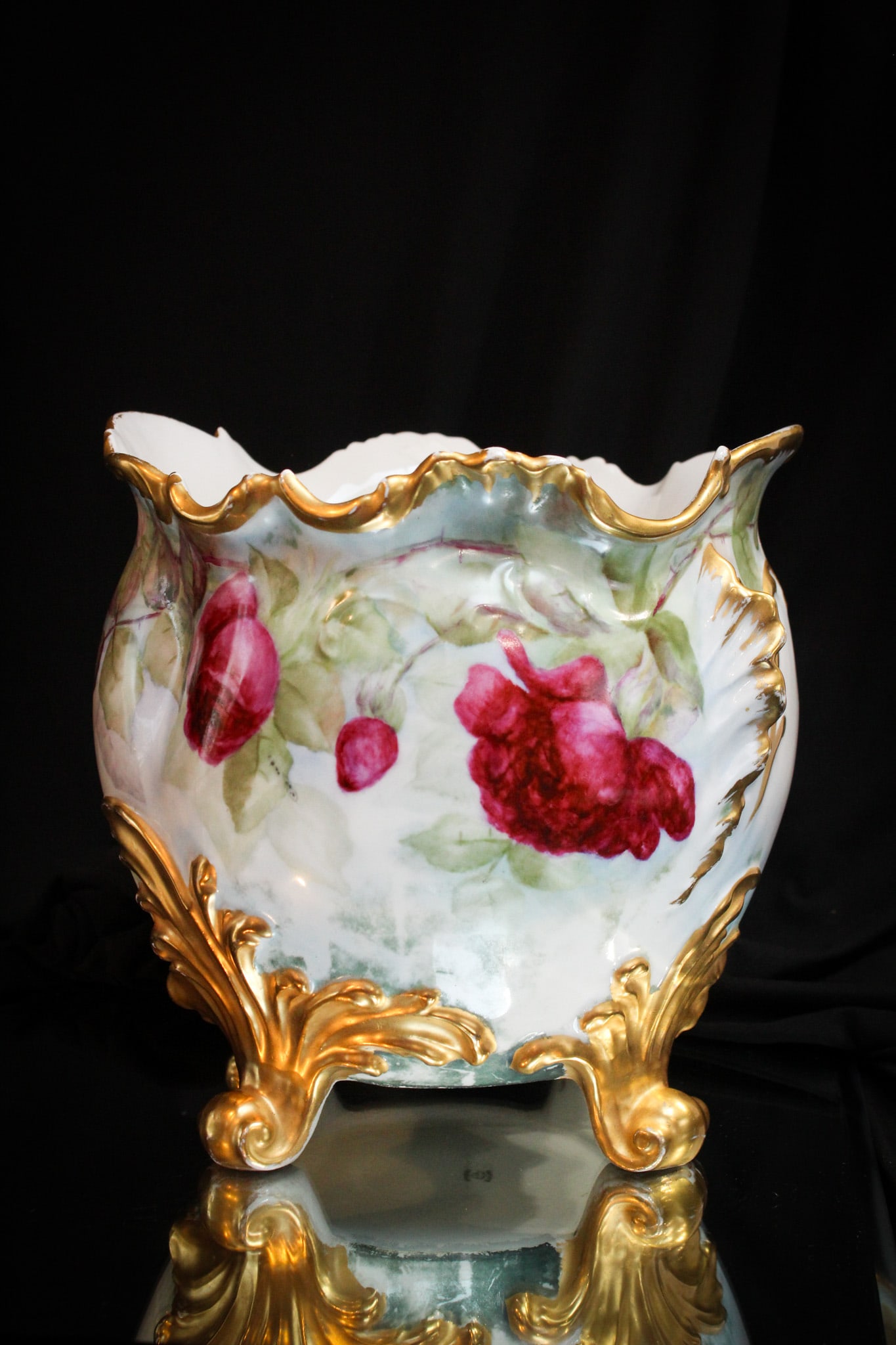 Limoges footed Hand Painted Porcelain Jardinere: Super hand painted porcelain jardinere decorated with roses and lots of gold. This jardinere is unique as it has four feet to stand on.