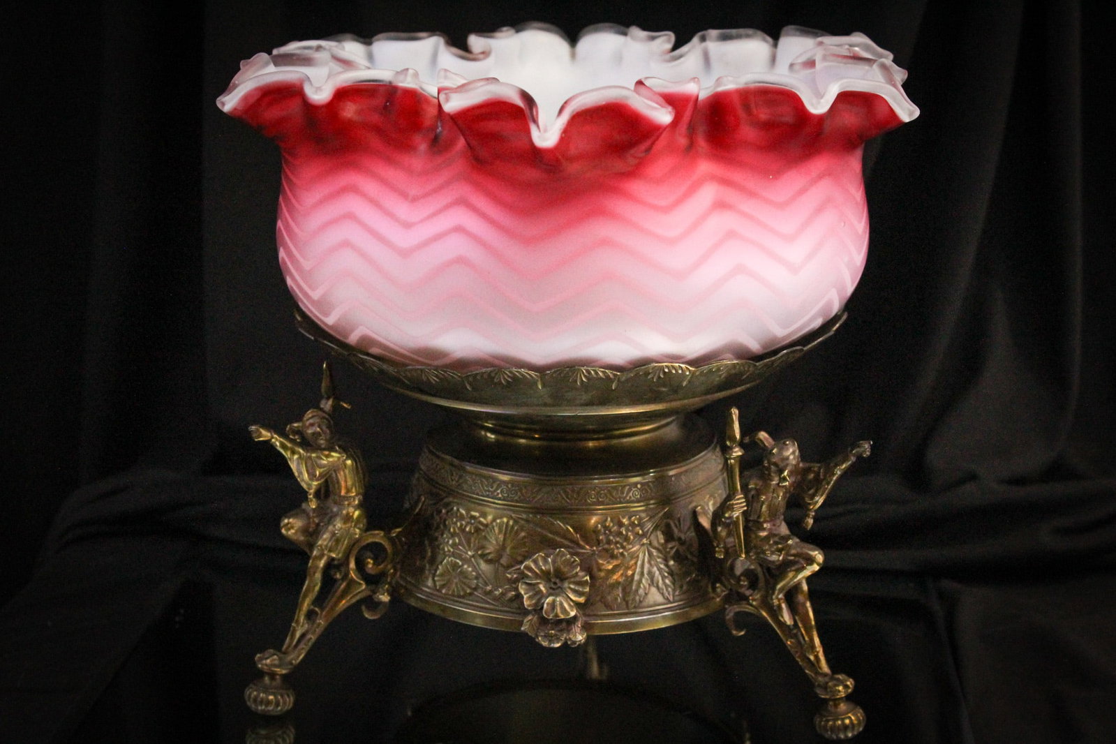 Meriden Gold Jester Mother of Pearl Brides Bowl Centerpiece: Beautiful signed "Meriden" gold toned holder with figural jesters. Holder comes complete with deep pink shaded herringbone pattern brides bowl. So showy! Measures 9 1/4" tall, by 10 1/2" across.