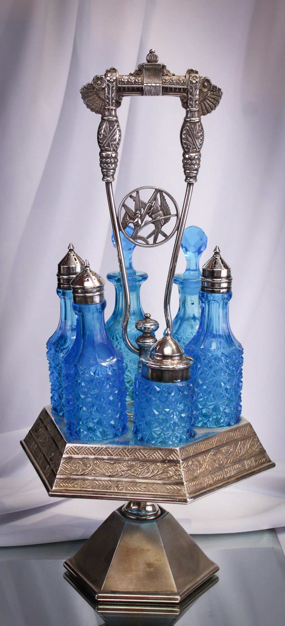 Pairpoint Victorian Silverplate Blue Daisy & Button Castor Set: Super Victorian castor set in signed "Pairpoint" silverplate frame complete with beautiful vibrant blue "Daisy & Button" pattern bottles with original stoppers. Stunning set!