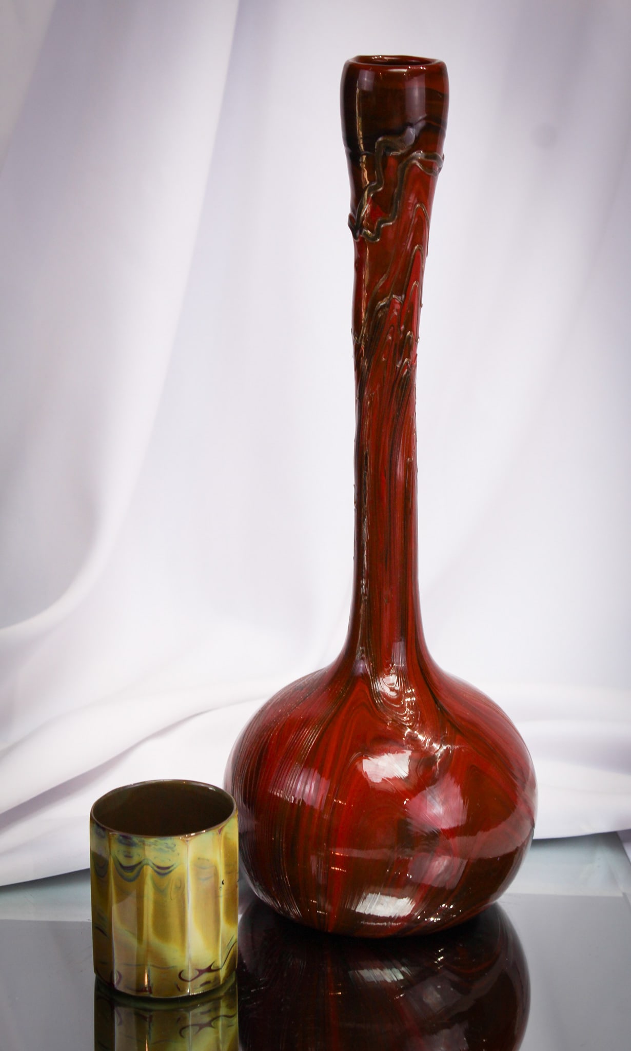 2 pc Lot Lithyalin Fredrich Egermann Art Glass: Nice pairing of two unusual and rare pieces of Lithyalin glass by Fredrich Egermann. This lot is comprised of a tall bottle neck vase and cup or toothpick.