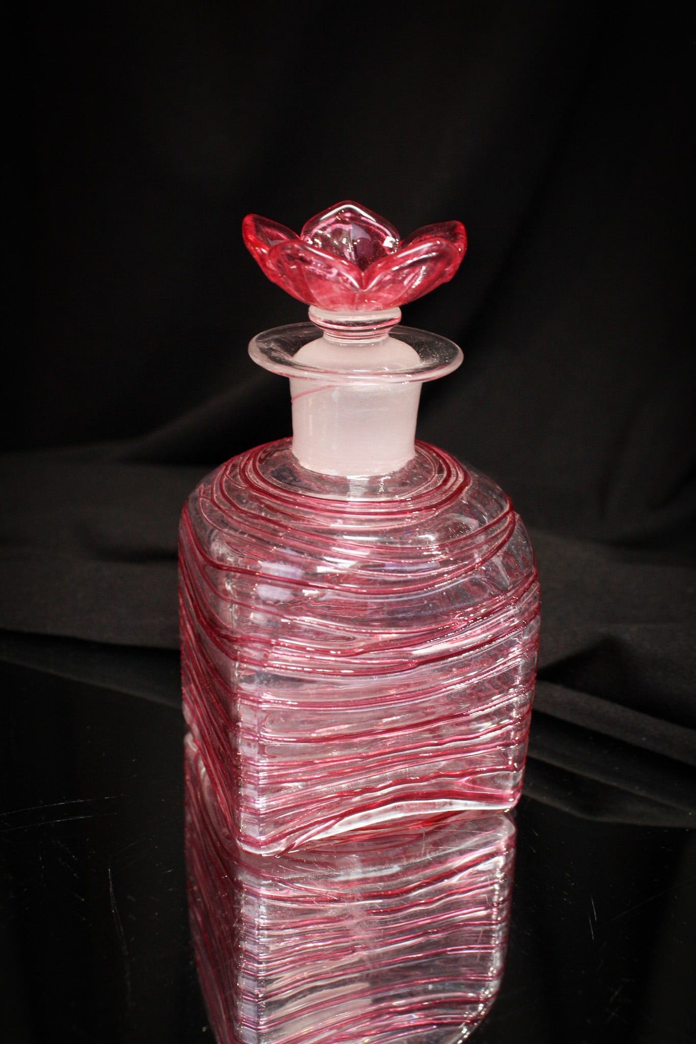 Steuben Glass Gold Ruby Threaded Flower Stopper Cologne: Steuben classic in this clear with Gold Ruby threading cologne. Bottle is complete with flower form stopper. Signed as shown.