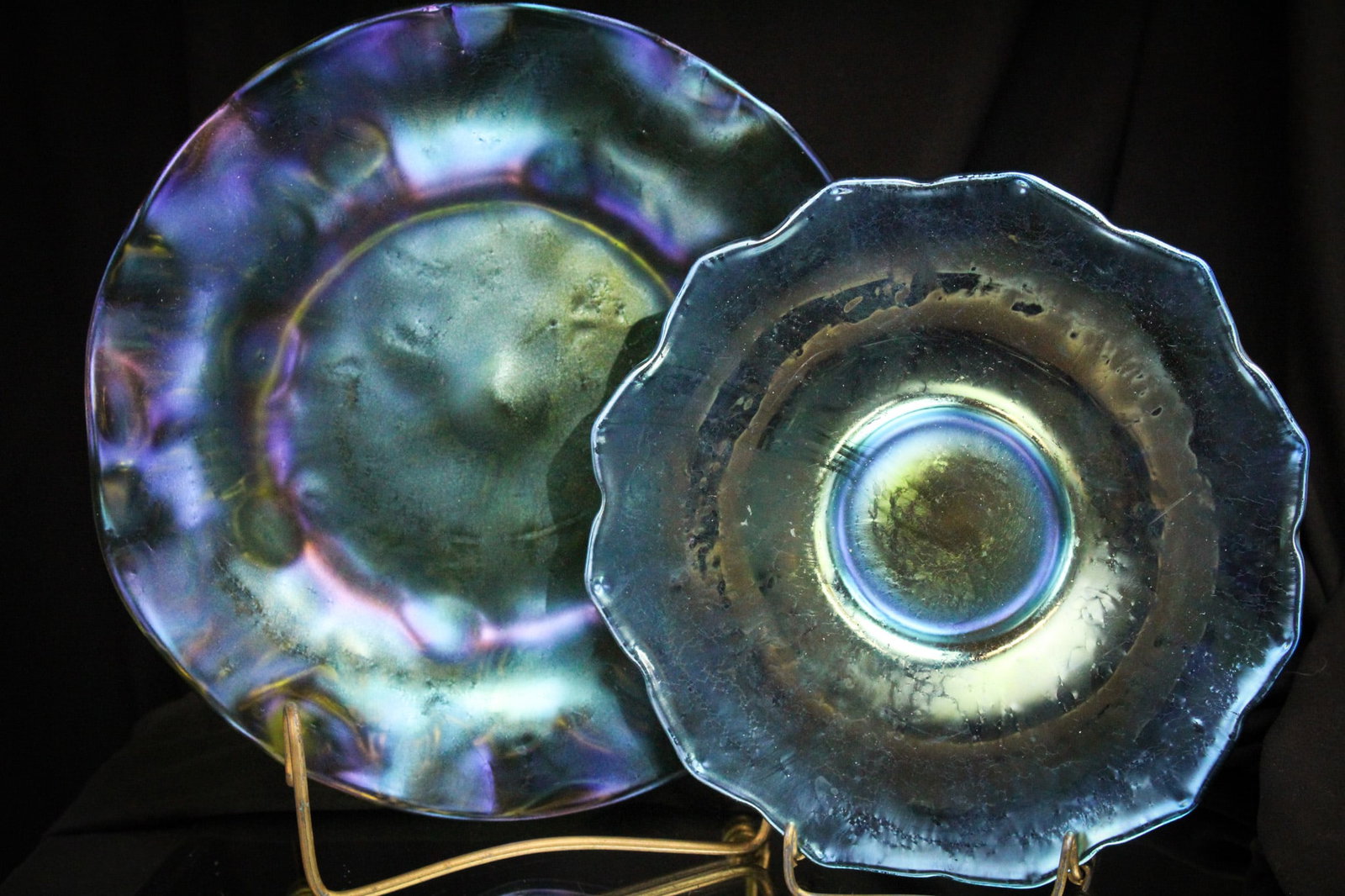 2 pc Lot Signed Loetz Austria Rusticana & Papillon: Great pairing of two unique signed pieces of "Loetz Austria" glass. A green "Rusticana" plate is paired with an underplate in blue "Papillon". Both signed and both nice! Largest measures 9" in diamete
