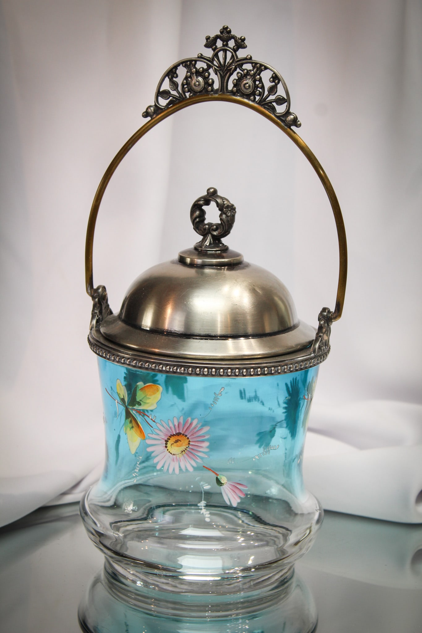 Bluerina Enameled Victorian Silverplate Biscuit jar: Pretty corset shape Victorian blue to clear shaded with enameled dÃ©cor Victorian biscuit jar. Piece retains the original lid and mountings. Nice example!