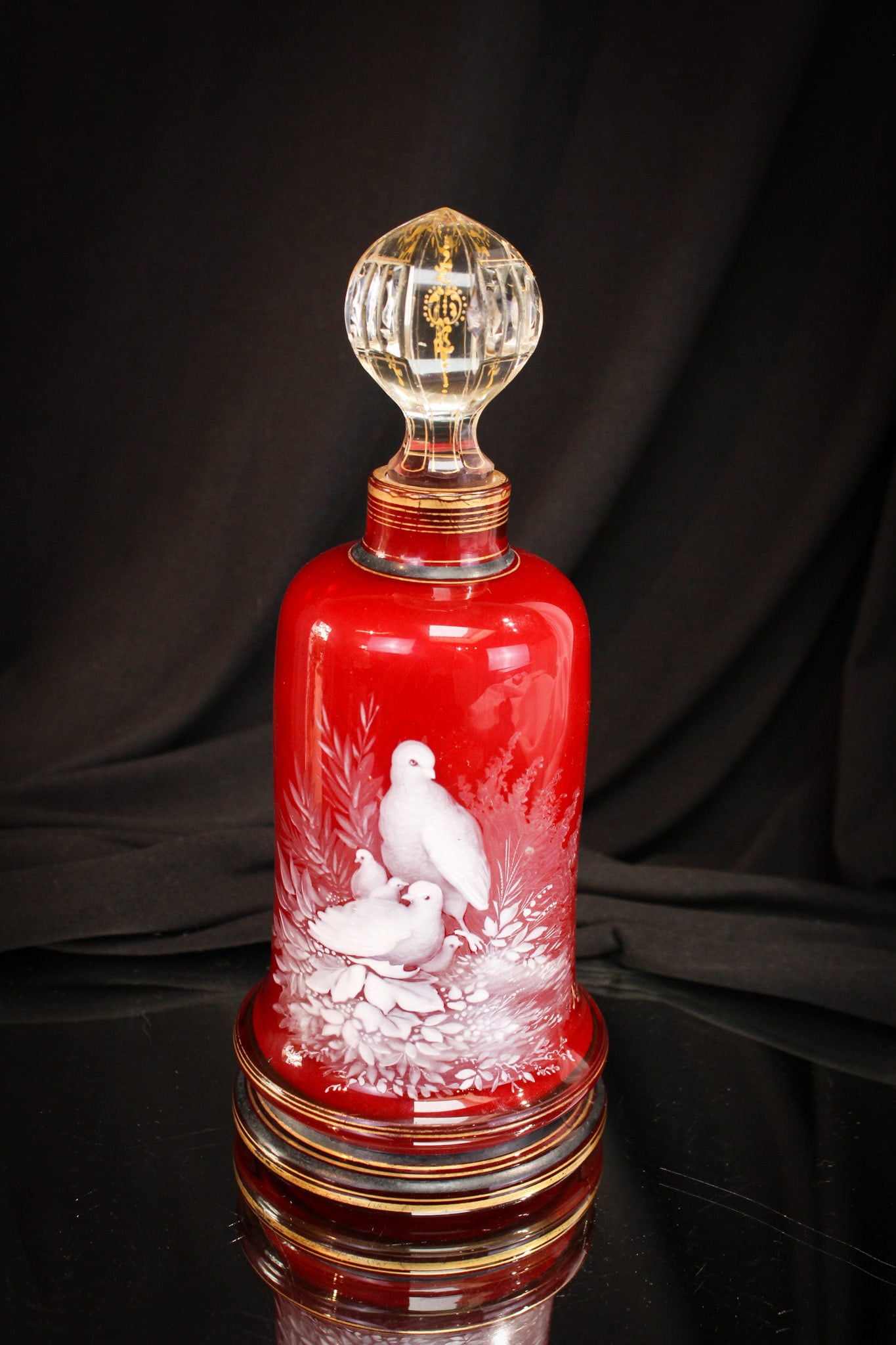 Cased Victorian Glass Enameled Cologne Bottle: Gorgeous deep burgundy cased with crisp white lining cologne bottle. This Victorian piece is enameled with a charming bird family. Adorable. Marked AHNE.