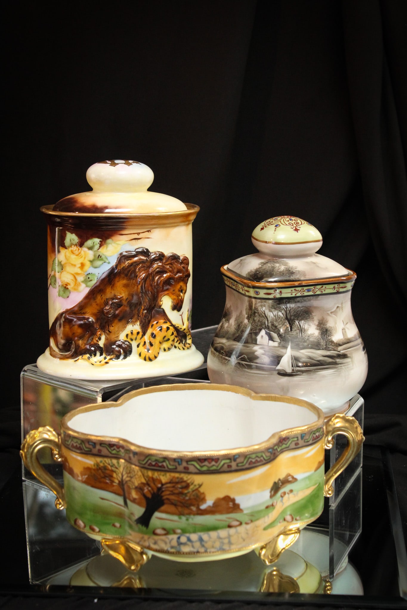 3 pc Lot Nippon Porcelain Humidors & More: Nice trio offering of signed and unsigned Nippon porcelain. The first example a lion and snake humidor, which is signed. The second, a scenic decoration ferner, also signed. The third an unsigned lake