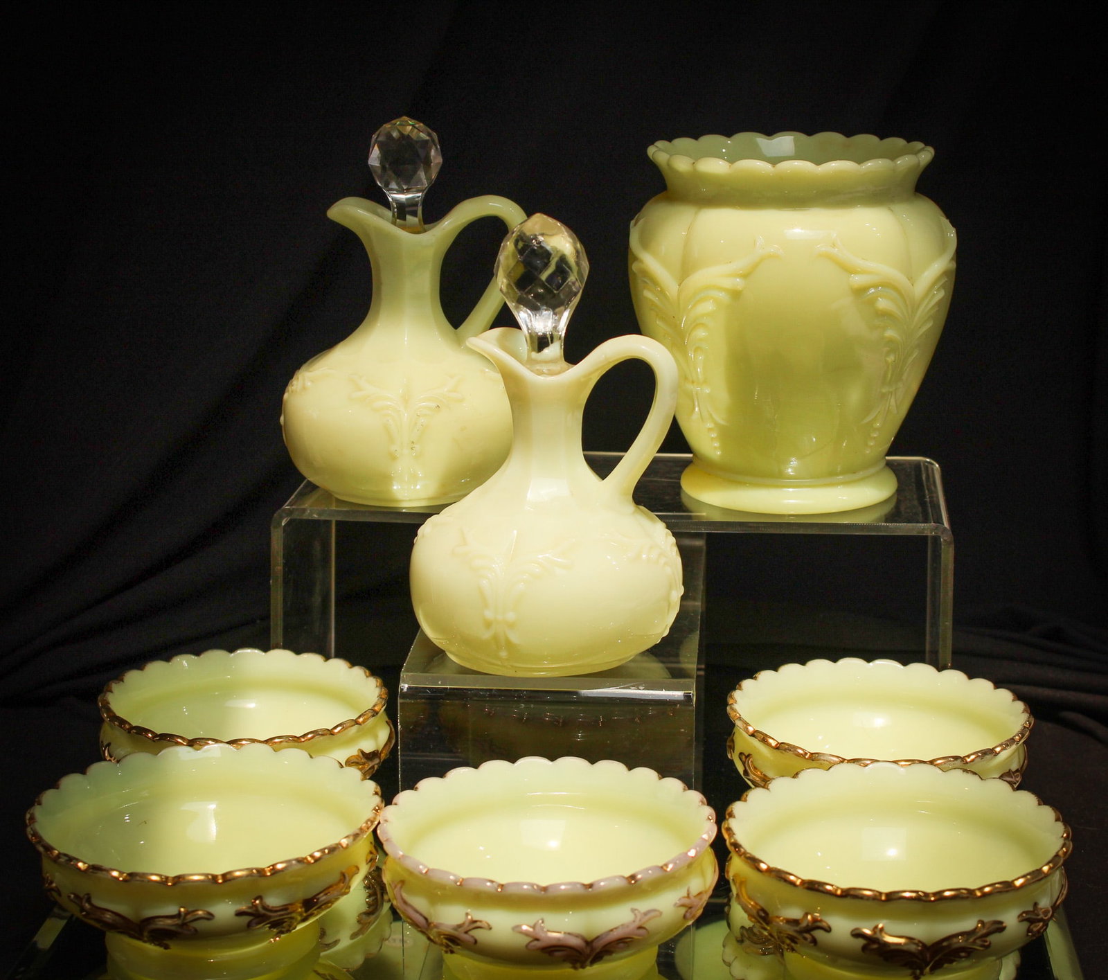 8 pc Lot Heisey Glass Winged Scroll: Generous offering of eight select examples of Heisey glass "Winged Scroll" pattern. Lot is made up of a celery, two cruets, and five individual berry bowls.