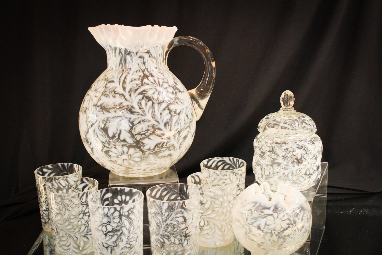 9 pc Lot Northwood Opalescent Victorian Glass: Nine fine pieces of Northwood makes up this fancy of a lot in Northwood opalescent glass. A complete 7 piece water set along with a "Daisy and Fern" rose bowl, and covered sugar in the "Parian Swirl" 
