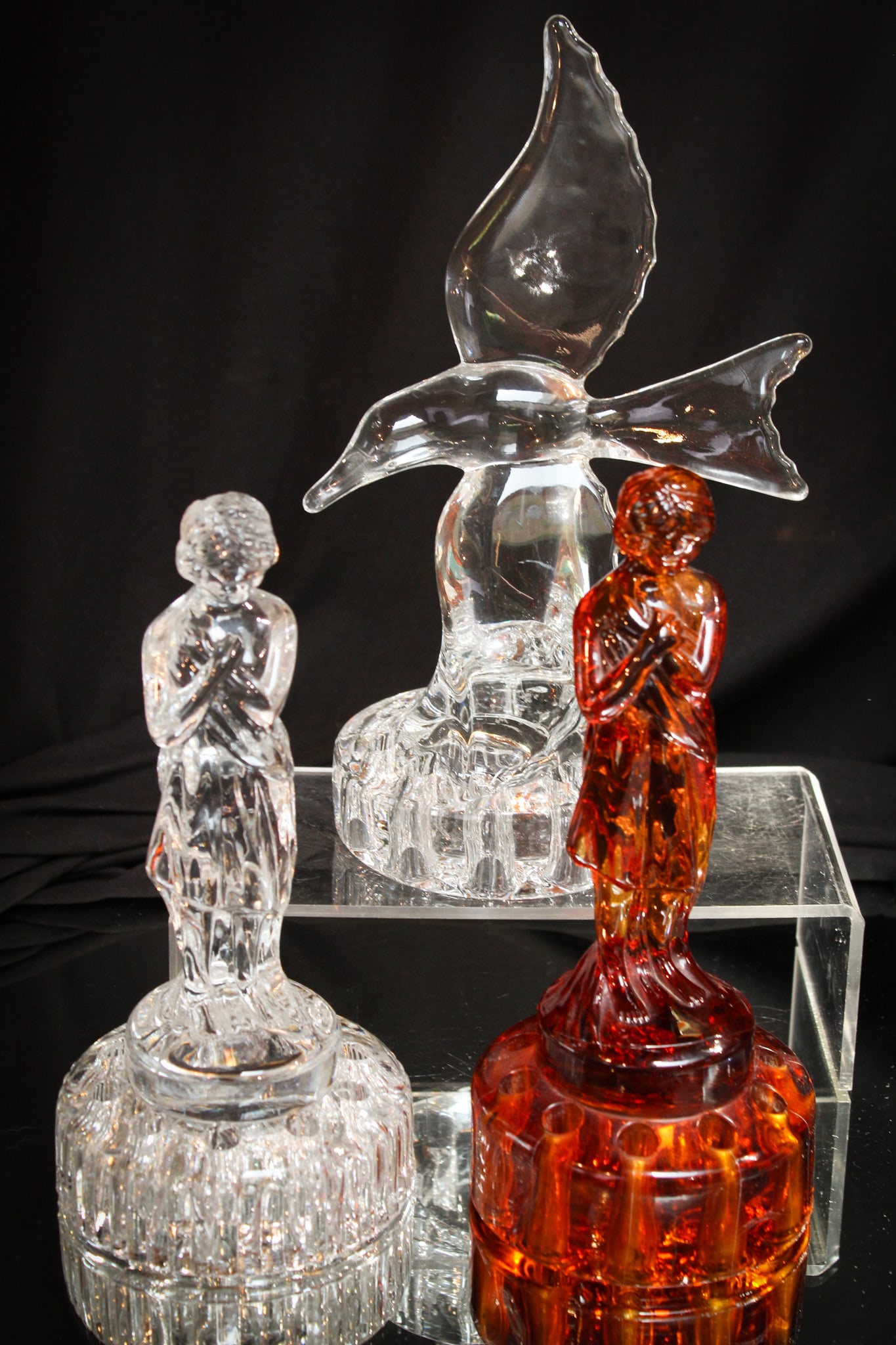 3 pc Lot Figural Cambridge Glass Flower Frogs: Three great examples of Cambridge glass flower frogs represented by a clear "Seagull" and a clear and amber "Draped Lady" make up this select offering.