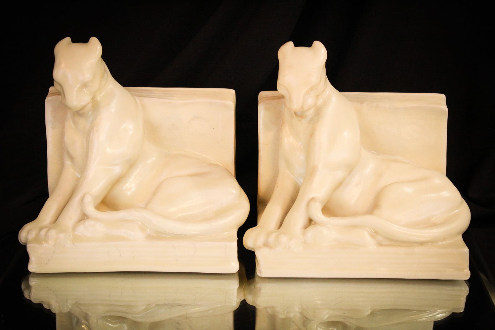 Rookwood Pottery Panther Bookends: Select offering here of a pair of signed Rookwood bookends. Marked, "XLV" and numbered "2564". Each measures 5 3/4" tall, 6" wide.