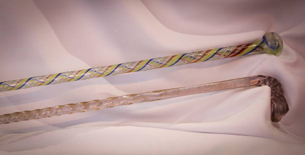 2 pc Lot Antique Blown Glass Parade Canes: Fine two piece lot of antique blown glass parade canes. One clear example. One with ribbon twisted body. Largest measures 50".