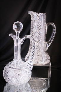 2 pc Lot ABP Brilliant Cut Glass Decanter & Pitcher: Two fine examples of American Brilliant Period cut glass comprised of a decanter with stopper along with a pitcher. Tallest measures 12".