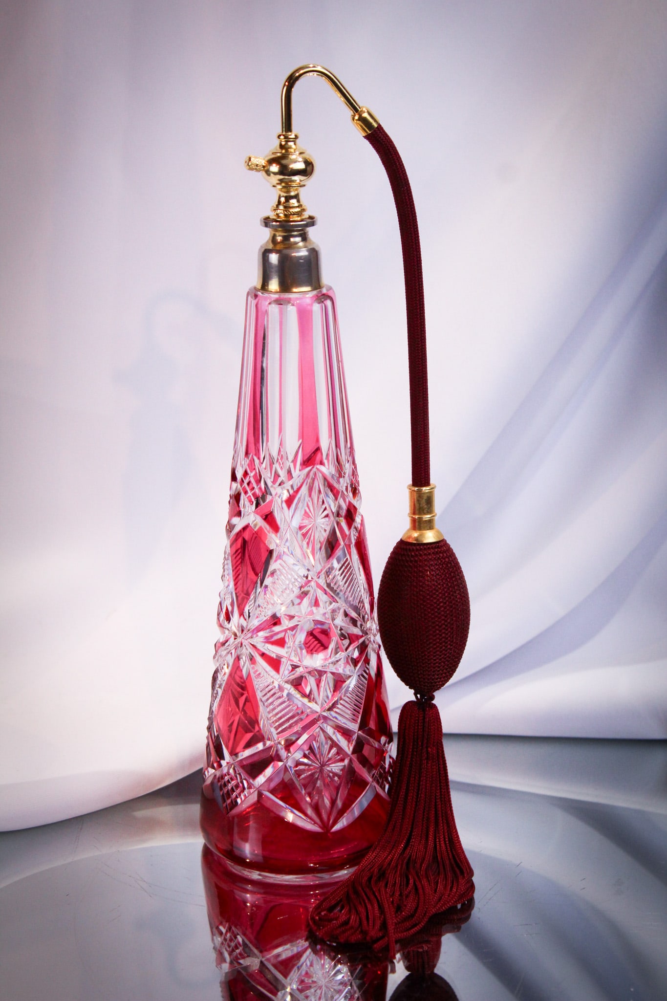 Cranberry Cut to Clear Atomizer: Wonderful to spray your favorite pefume or cologne cranberry cut to clear atomizer. This piece possibly by Val St. Lambert or Baccarat measures 11" tall. Great offering.