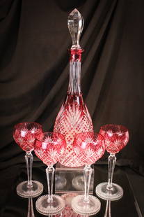 Cranberry Cut to Clear Glass 5pc Decanter & Goblets: Fine offering of a decanter and set of four goblets in cranberry cut to clear. Decanter measures 15 1/2" tall.