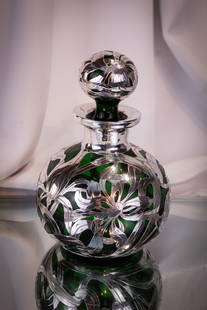Sterling Silver Overlay Antique Green Glass Cologne Perfume Bottle: Gorgeous sterling silver overlay antique glass in emerald green colorgn or perfume bottle. Monogramed on the neck, this lovely example is covered in sterling silver. It stands 6 3/4" tall, 4 1/2" wide