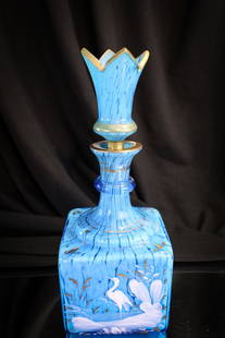 Victorian Spatter Cased Gilt Enameled Glass Perfume Cologne Bottle: Gorgeous blue Victorian glass perfume bottle cased on the interior with white spatter. Bottle is gilt and enamel decorated. Complete with original stopper. Nottle measures 7 1/2" tall, 3 1/2" wide.