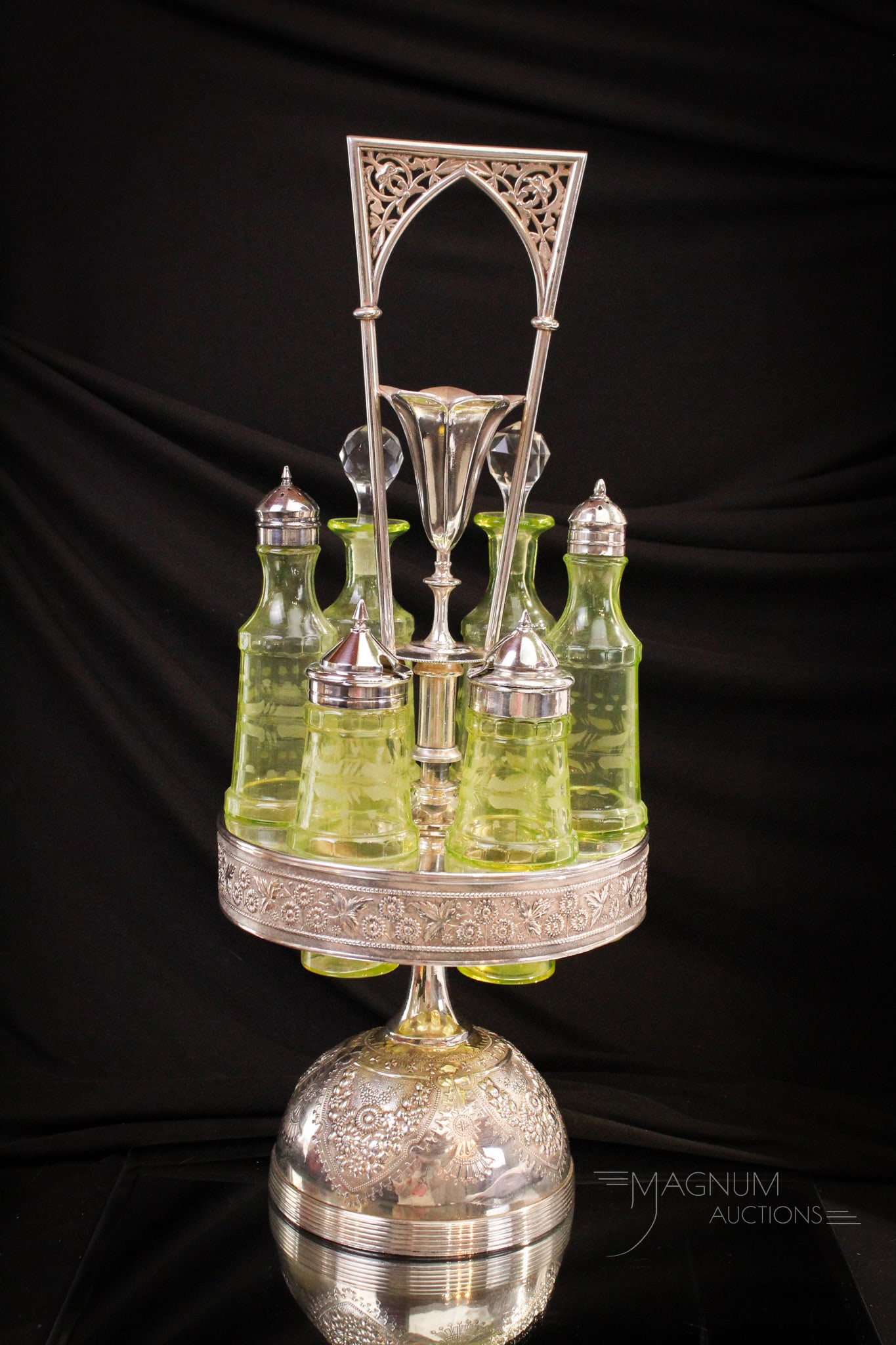 Meriden Silverplate 6 Bottle Vaseline Cruet Condiment Castor: Fine piece here, folks! A Victorian Meriden silverplate cruet condiment castor complete with a set of six engraved glass bottles. Center handle features a vase for flowers. Measures 18 3/4" tall.