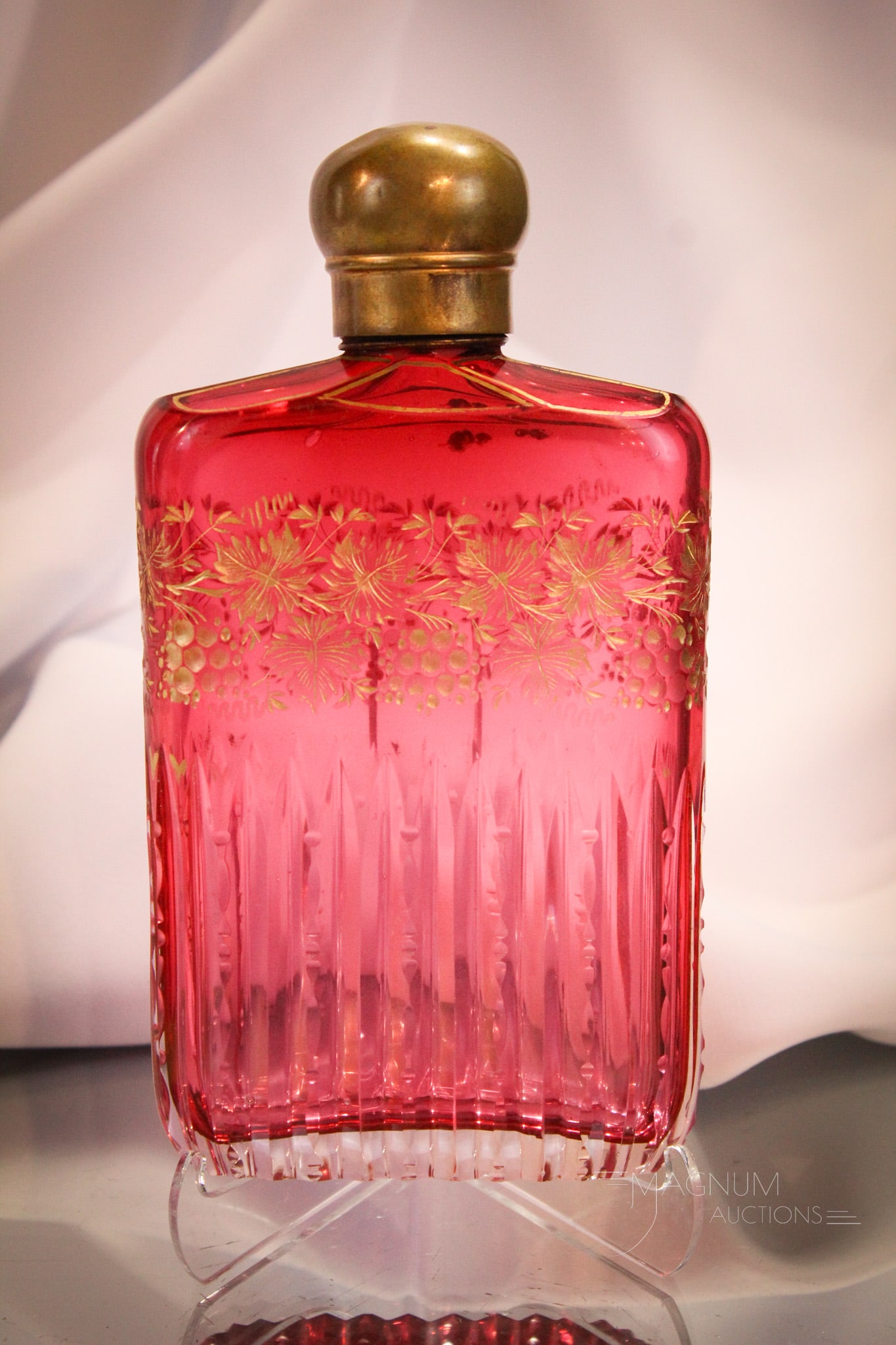 Antique Cranberry Cut Engraved Gilt Glass Flask: Beautiful cranberry antique cut and engraved glass flask with gilt decoration. This one adorned with grapes and foliage. Measures 7".