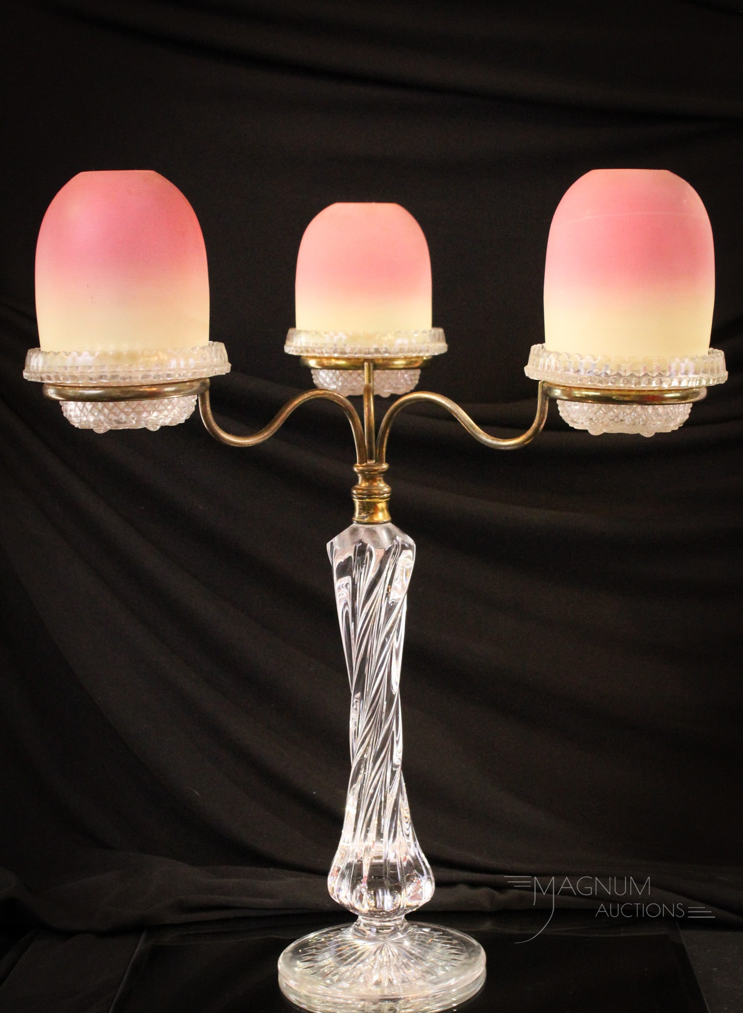 Webb Burmese Victorian Glass Fairy Lamp Candleabrum: Wonderful Webb burmese glass and crystal fairy lamp candleabrum. Piece is complete with three burmese art glass shades all complete on crystal signed Clarke's bases. Cut ray design on the base of the 