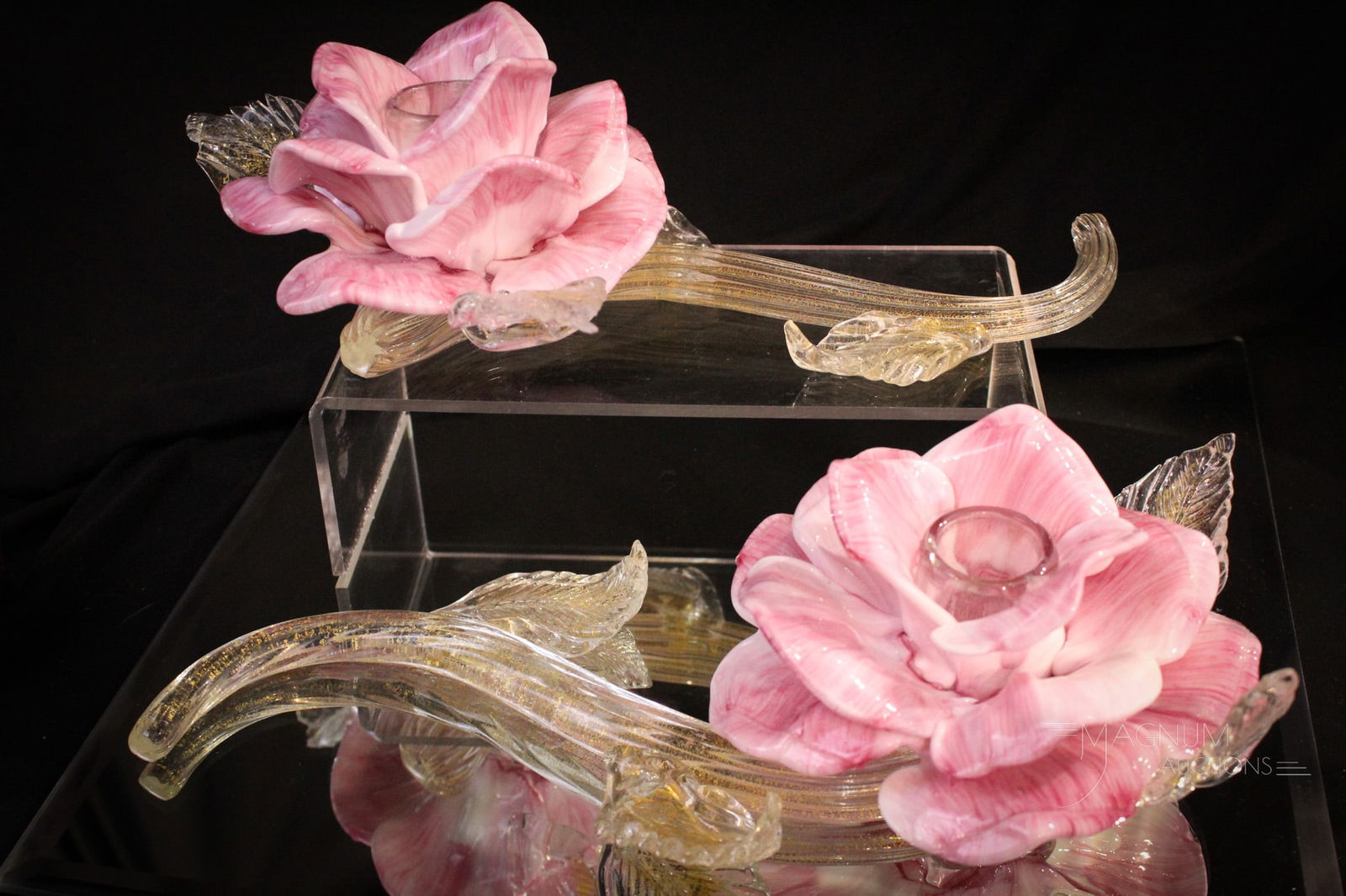 Italian MCM Murano Art Glass Rose Stem Candlesticks: Fine pair of curvacious full figure rose blossoms on swirling stem candle holders. Super mid century modern pieces of Italian art glass. Each with gold in the glass. Each measures 3 1/2" tall, 12" lon