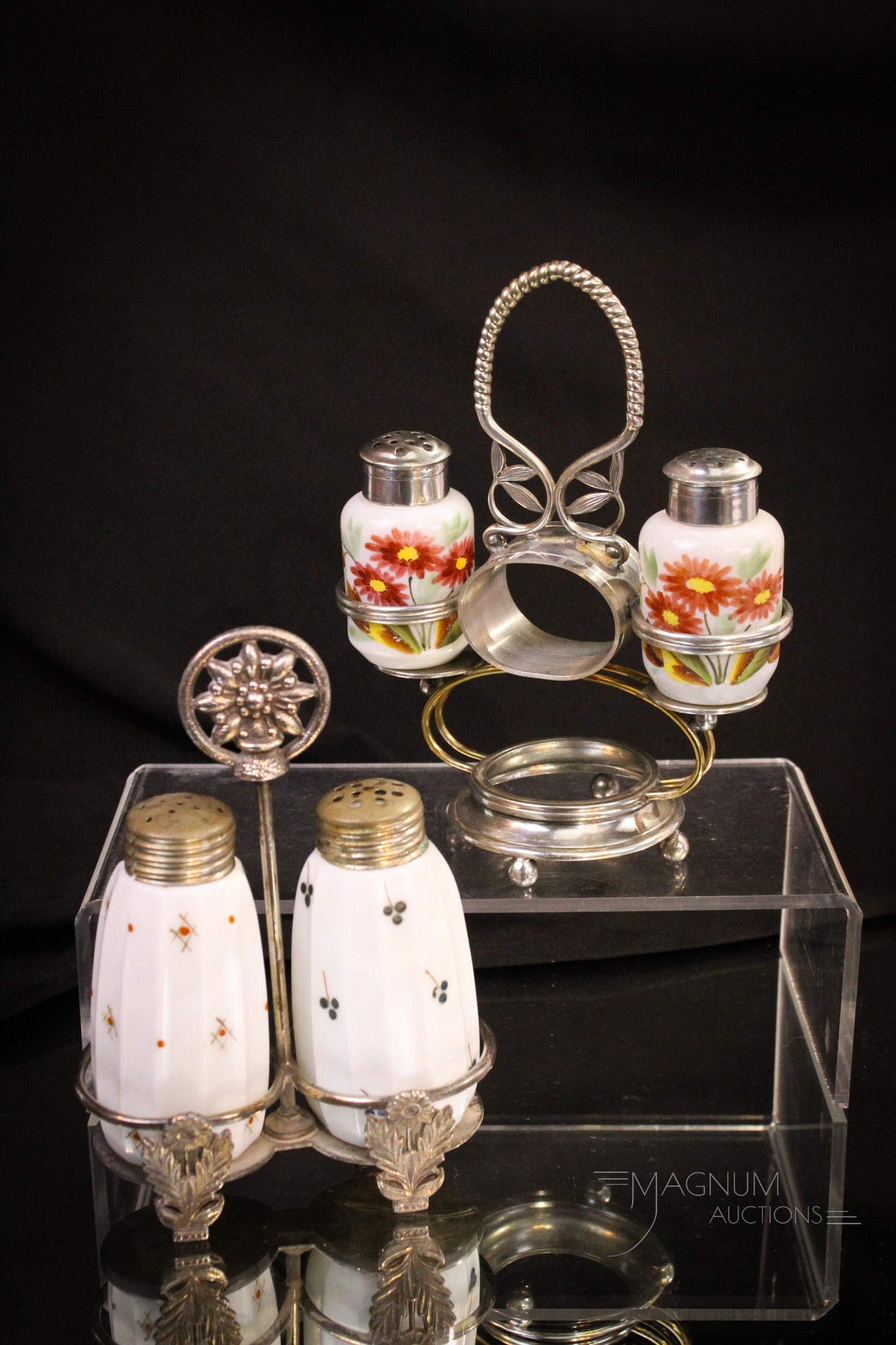 2 pc Lot Victorian Silverplate & Glass Shaker Sets: Two Victorian silverplate and glass shaker sets. Each a little different. One pair set in sigfned Acme silverplate holder with sunflower. The other with a built in napkin ring which is unsigned. Talle