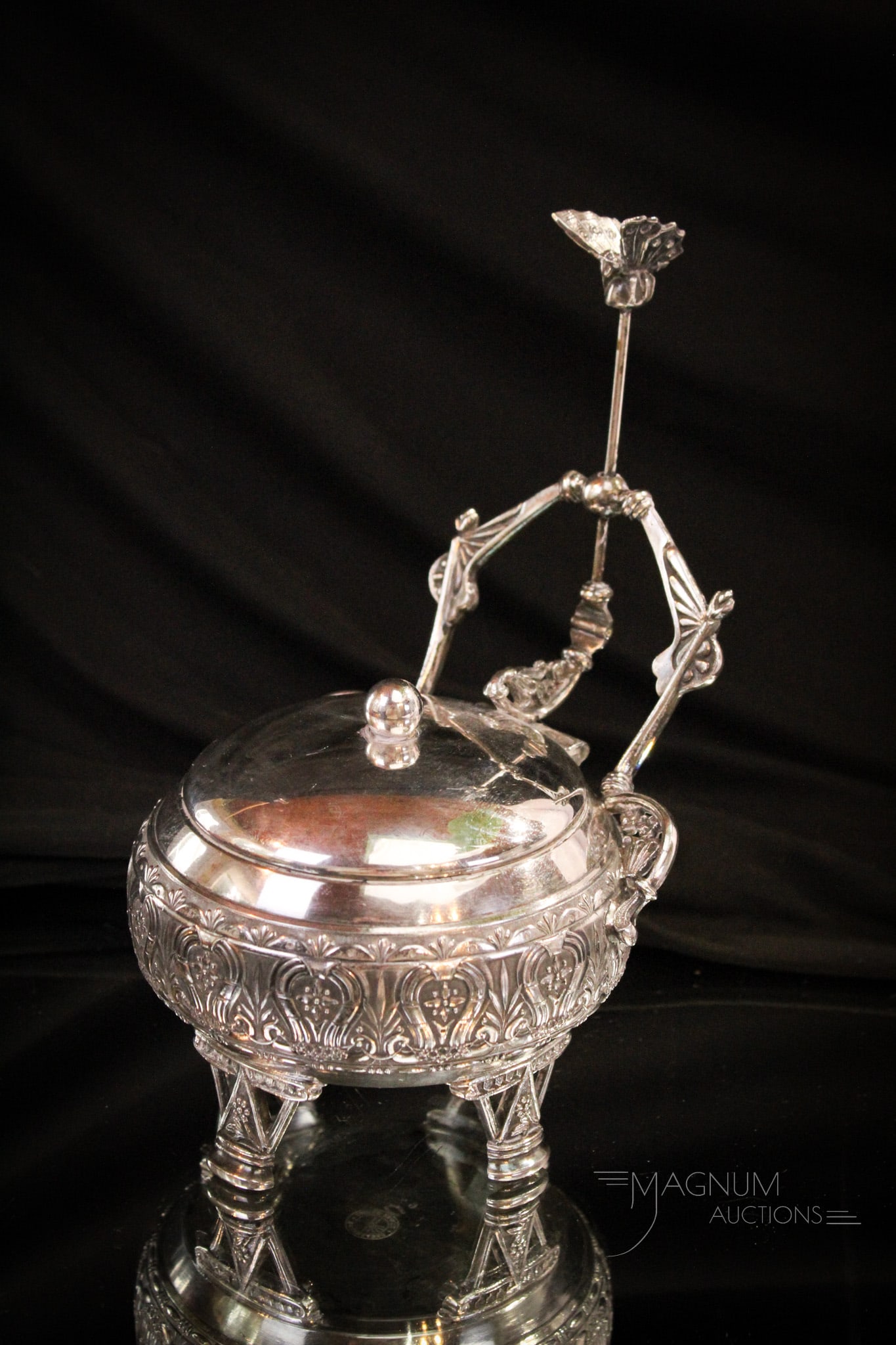 Victorian Mechanical Rogers Silverplate Jewelry Casket: A fine Victorian Rogers silverplate mechanical jewelry casket. Piece is complete with original lining in the lid. Casket features full winged butterfly on the top of the push down handle mechanism. Me