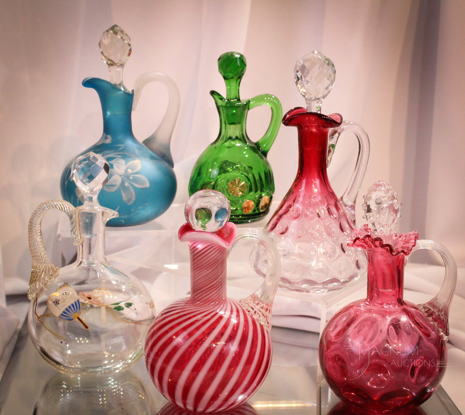 6 pc Lot Victorian Cranberry & More Glass Cruets: Six pretty art glass cruets. Some Victorian, some Fenton. Cranberry, rubina, opalescent, and pattern glass. One each as nice as the next. Tallest measures 7".