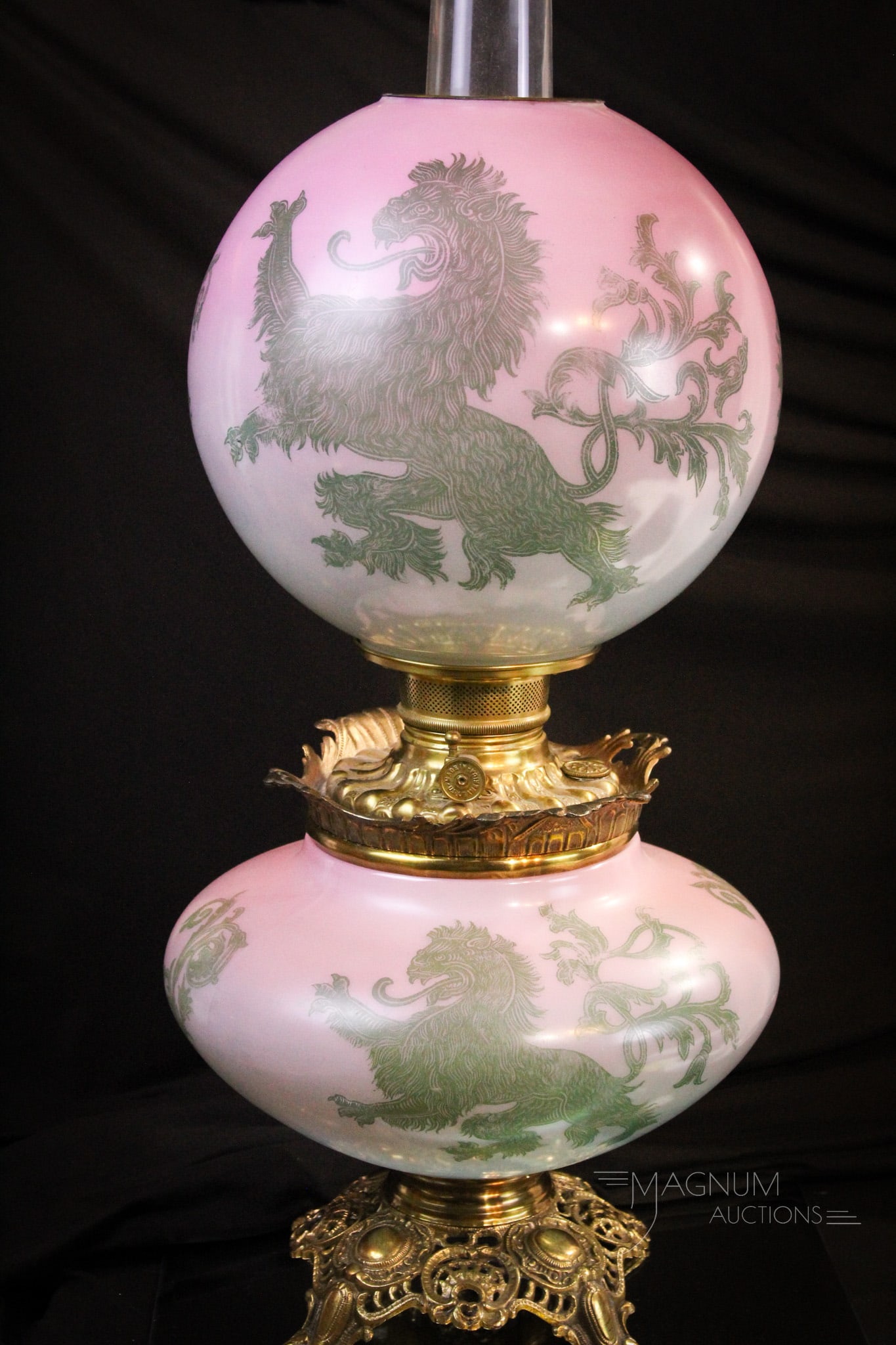 Scarce Rampant Lion Victorian Gone with the Wind Oil Lamp: Very scarce and unusually decorated Victorian gone with the wind lamp in shades of pinks and greens. This one is decorated with rampant lions in green. Lamp measures 22" tall.