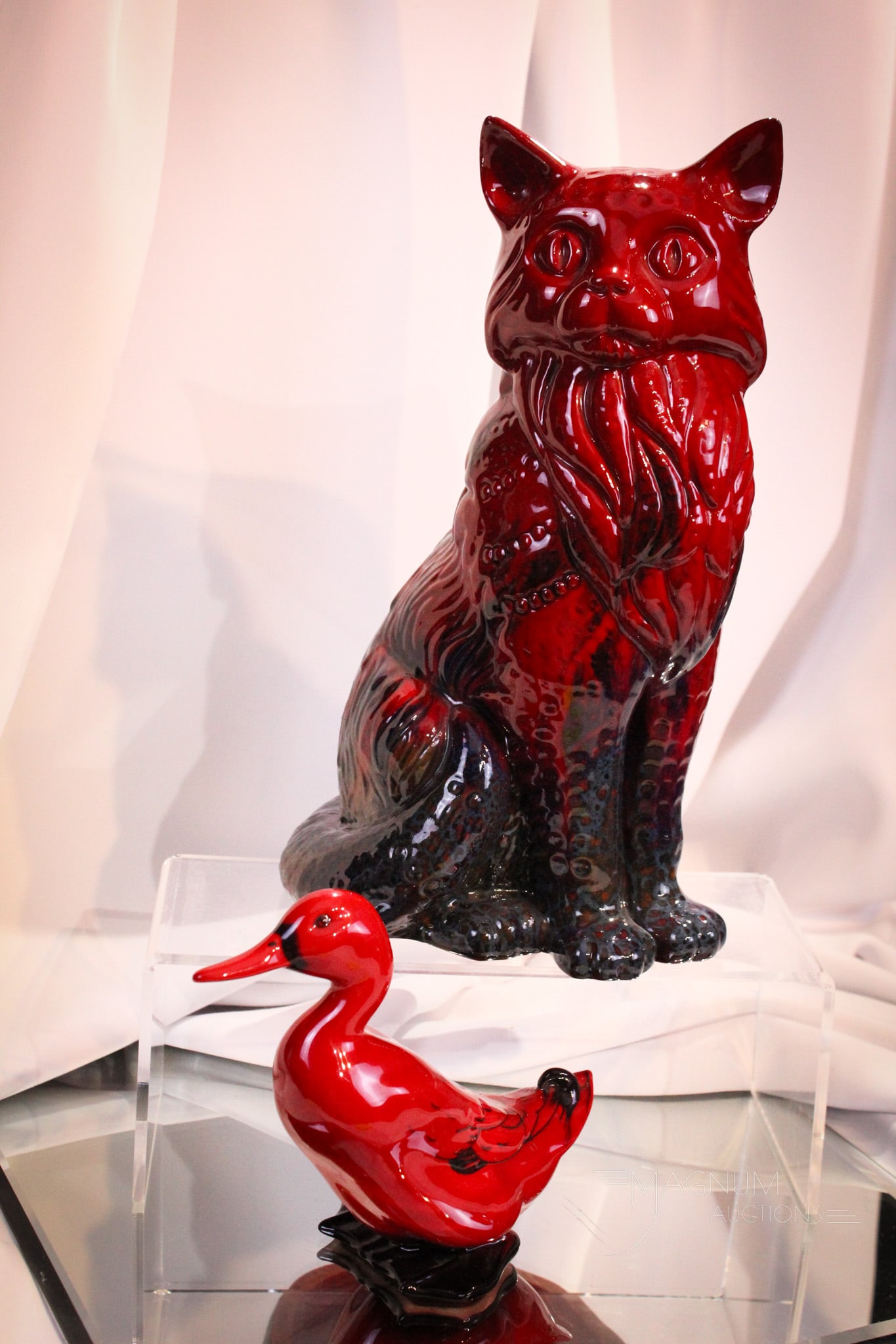 2 pc Lot Royal Doulton Flambe Porcelain Figurines: Two great examples of Royal Doulton Flambe. This lot is made up of a large feline pussy cat along with a duck. Largest measures 12".