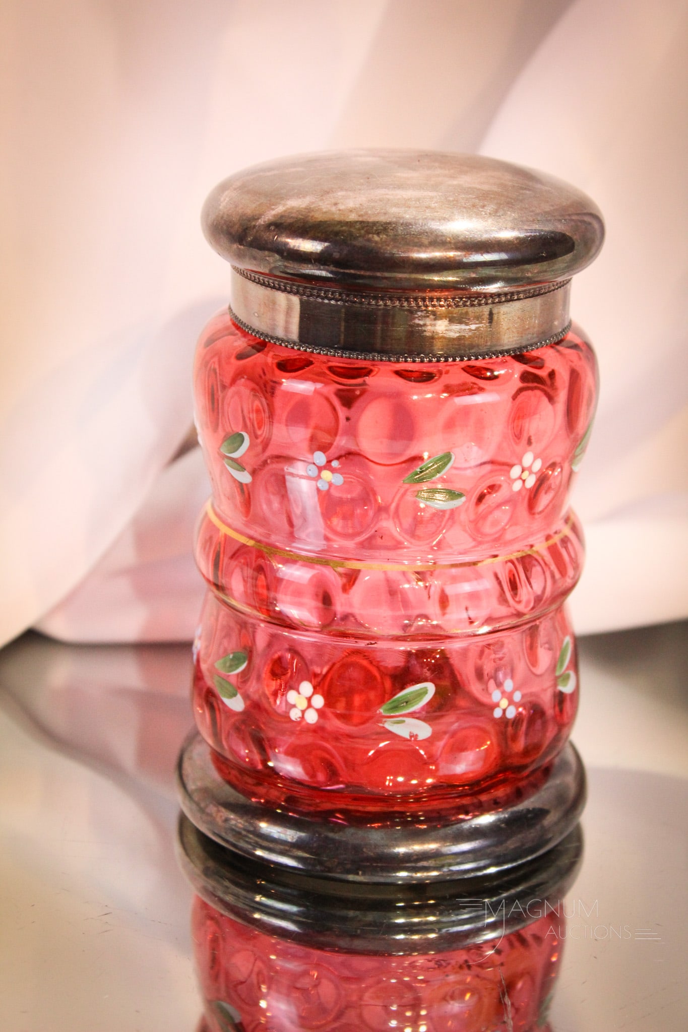Pairpoint Silverplate Cranberry Enameled Glass Bon Bon Jar: Fine cranberry bulging midriff enamel decorated bon bon jar with silverplate lid and marked Pairpoint silverplate base. Measures 5 1/2" tall.