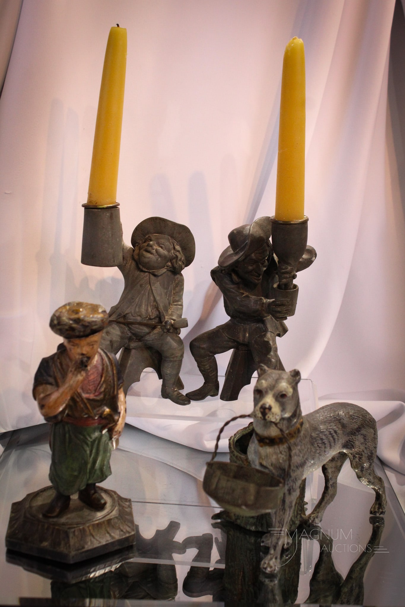 4 pc Lot Spelter Candlesticks Smoking Set & More: Nice offering of a pair of Bucaneer figural candlesticks and also a smoking man match safe along with a figural pooch smoking set. All items in cast spelter metal.