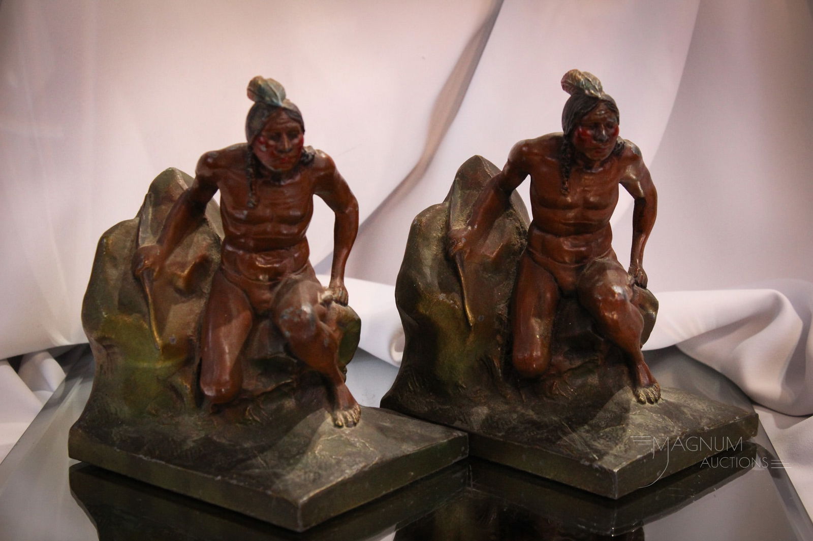 Cold Painted Bronze Cast Metal Native American Indian Bookend Pair: Nice pair of cast metal bookends in possibly bronze with cold painted accents. Each depicts a native American Indian. Each measures 6 1/2" tall.